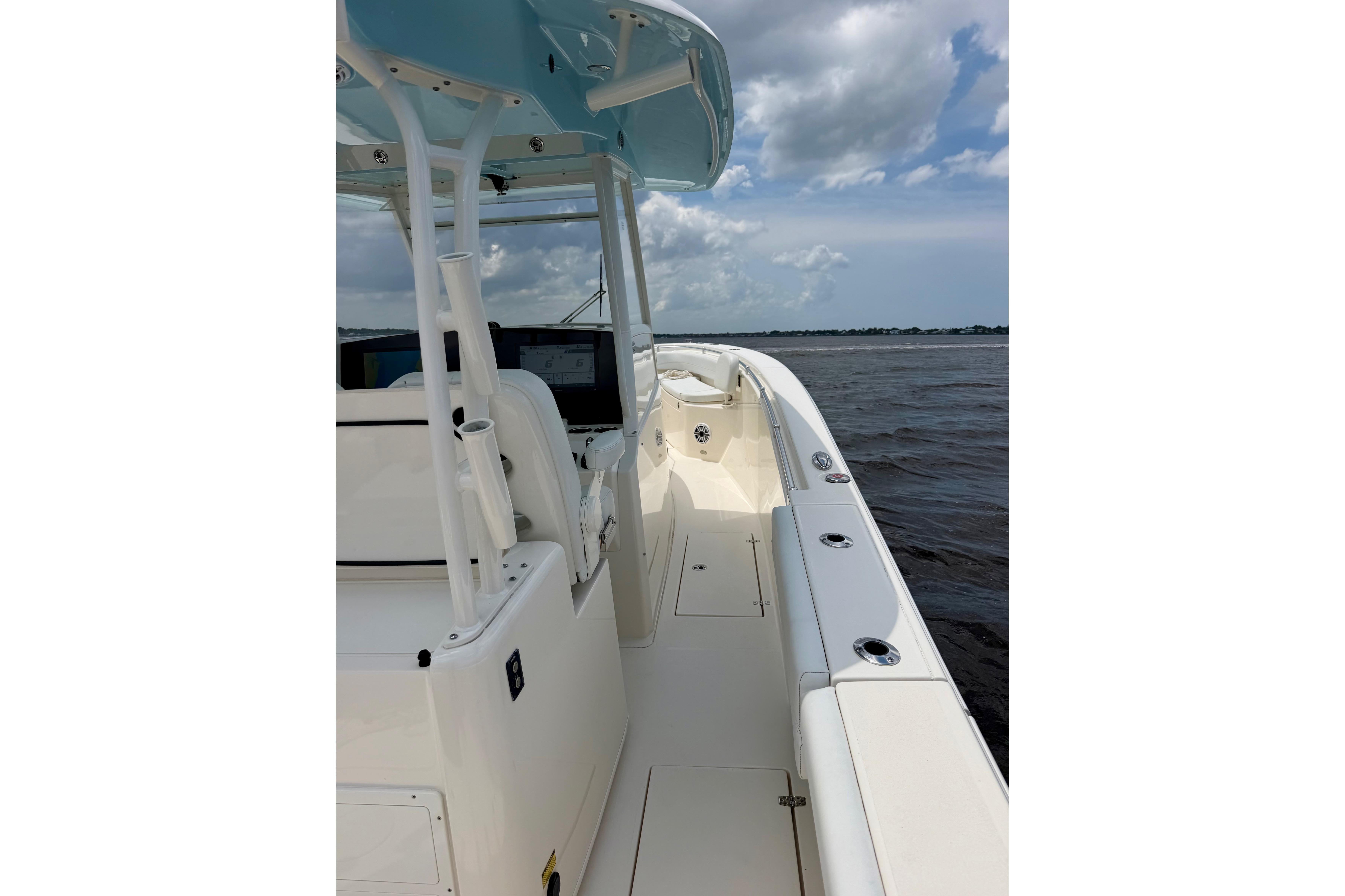 2023 Cobia 350 Center Console boat on open water under cloudy sky.