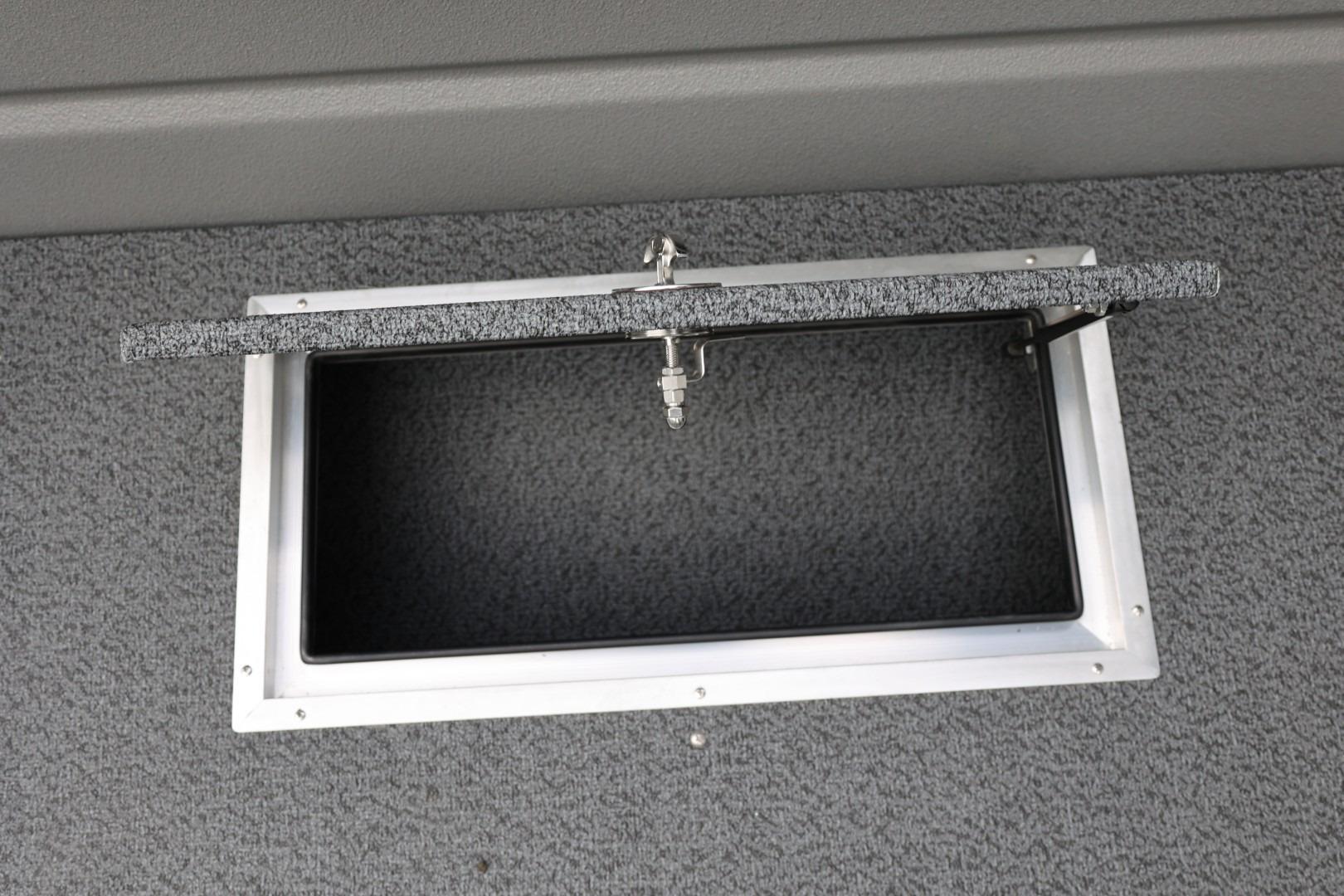 Open storage compartment on 2026 Thunder Jet 24 Alexis Pro boat, featuring a textured lid.