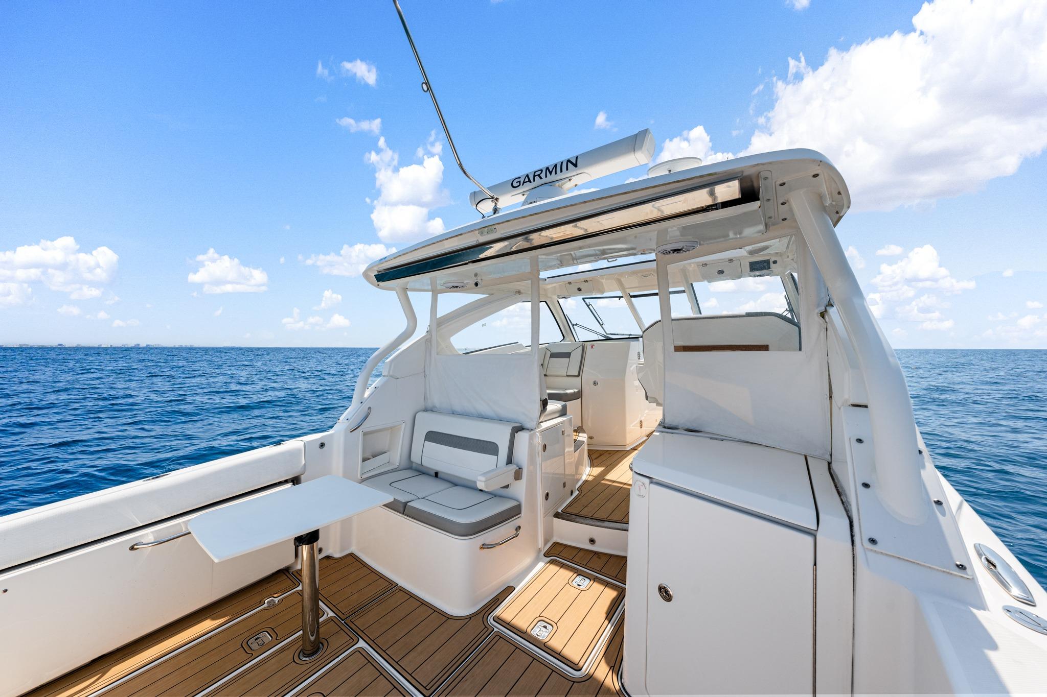 2022 Pursuit DC 365 Dual Console boat interior on open sea under blue sky.