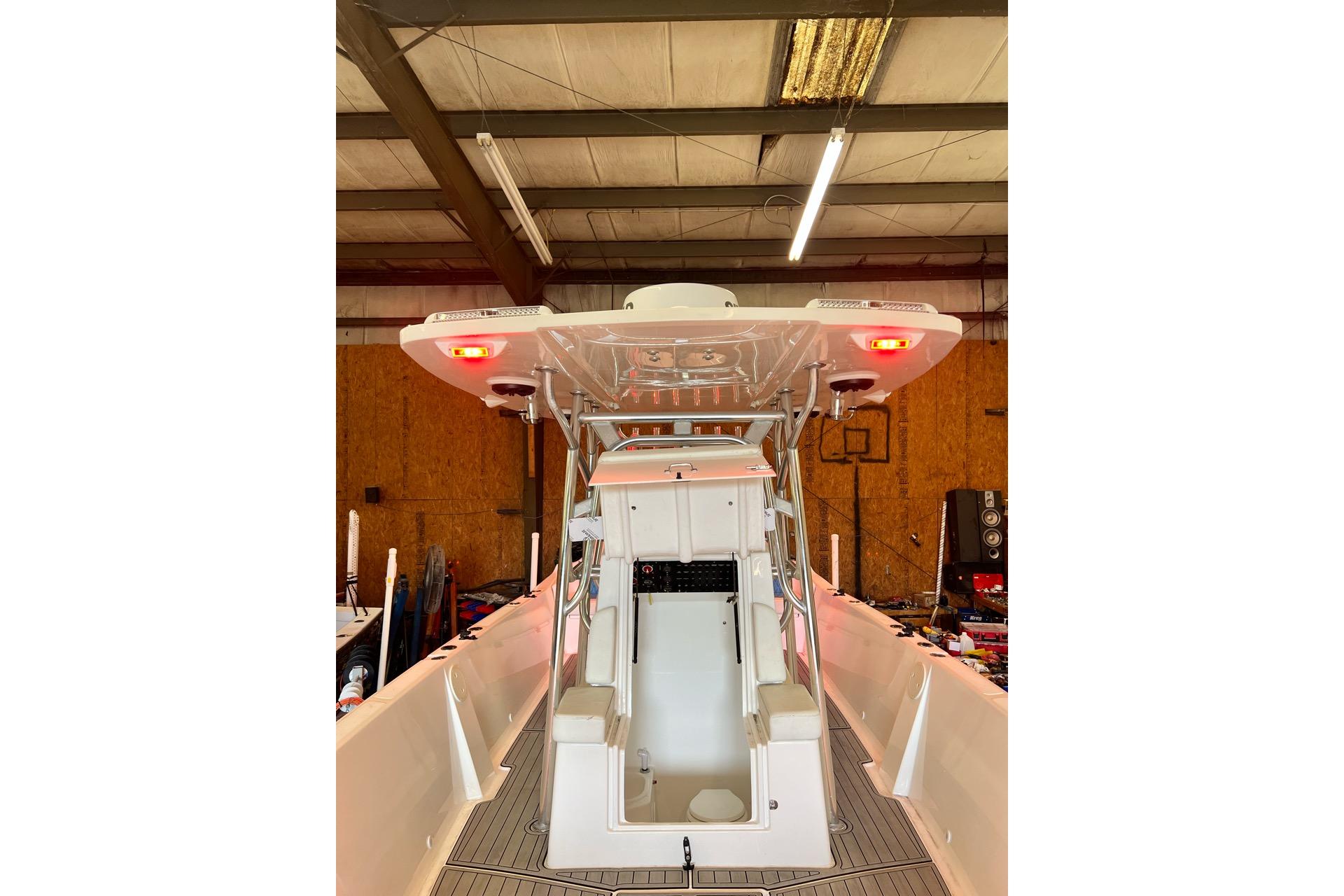 2021 Custom Infusion 34 CC boat interior in a warehouse setting.