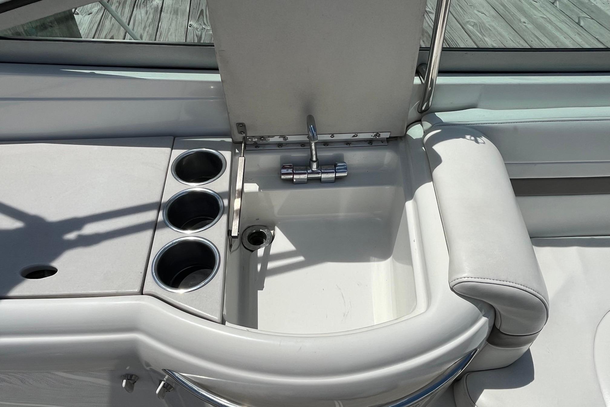 2002 Formula 330 Sun Sport boat sink and cup holders on deck.