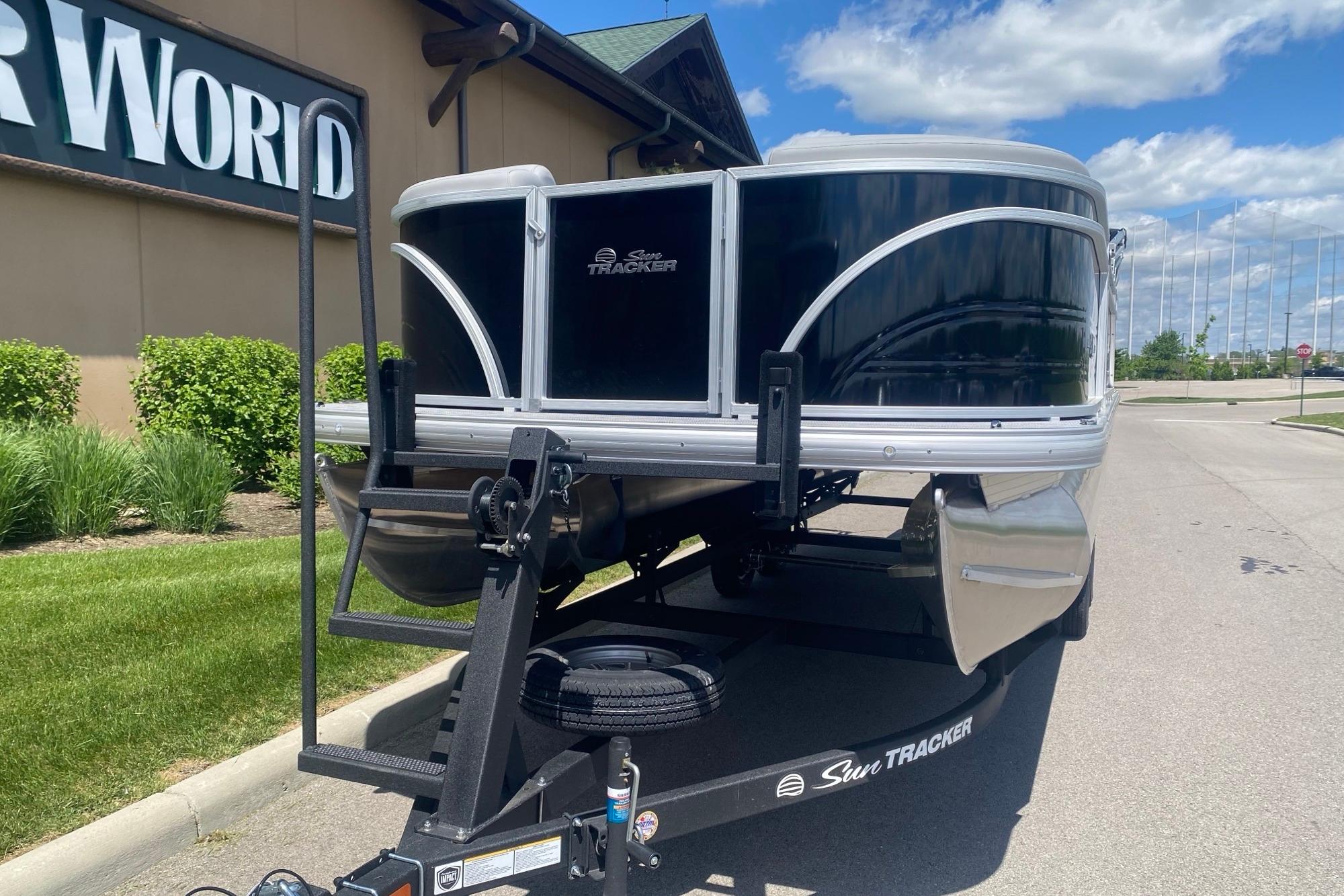 2026 Sun Tracker Party Barge 22 RF DLX pontoon boat on trailer, outdoors.