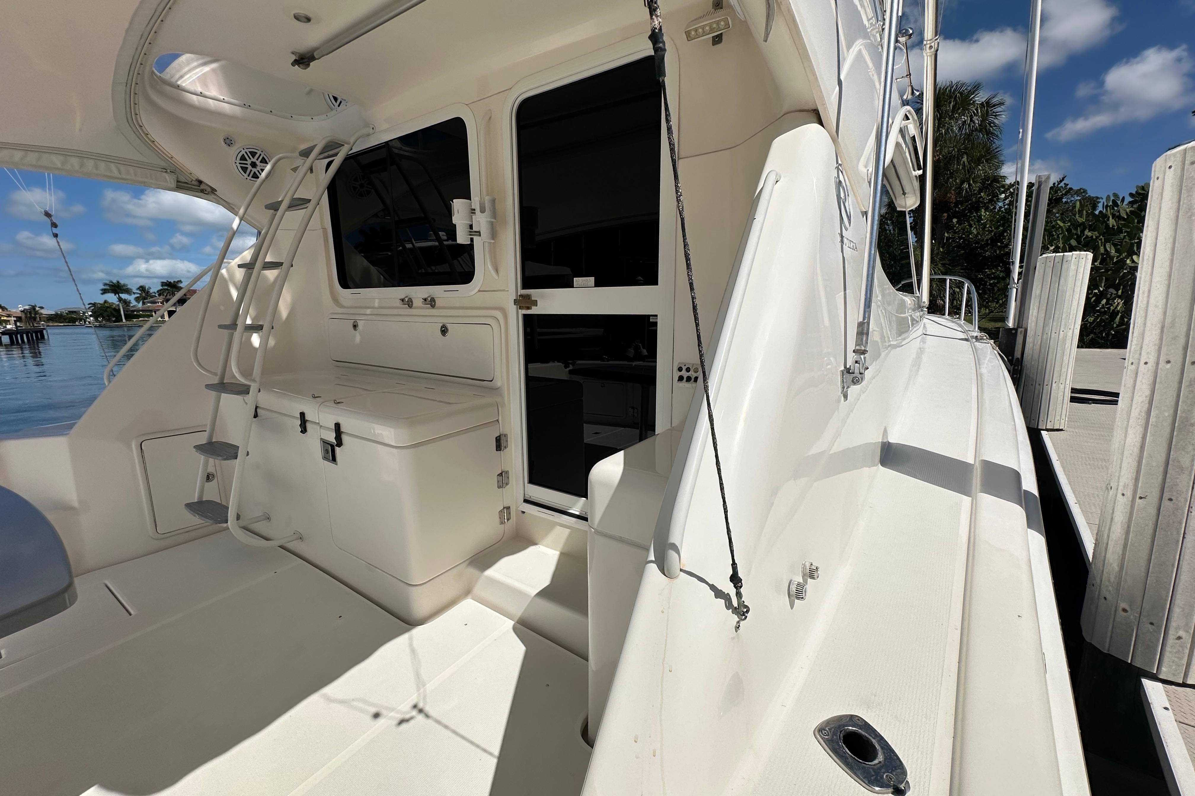 2002 Riviera 40 Flybridge yacht deck with ladder and storage, docked by water.