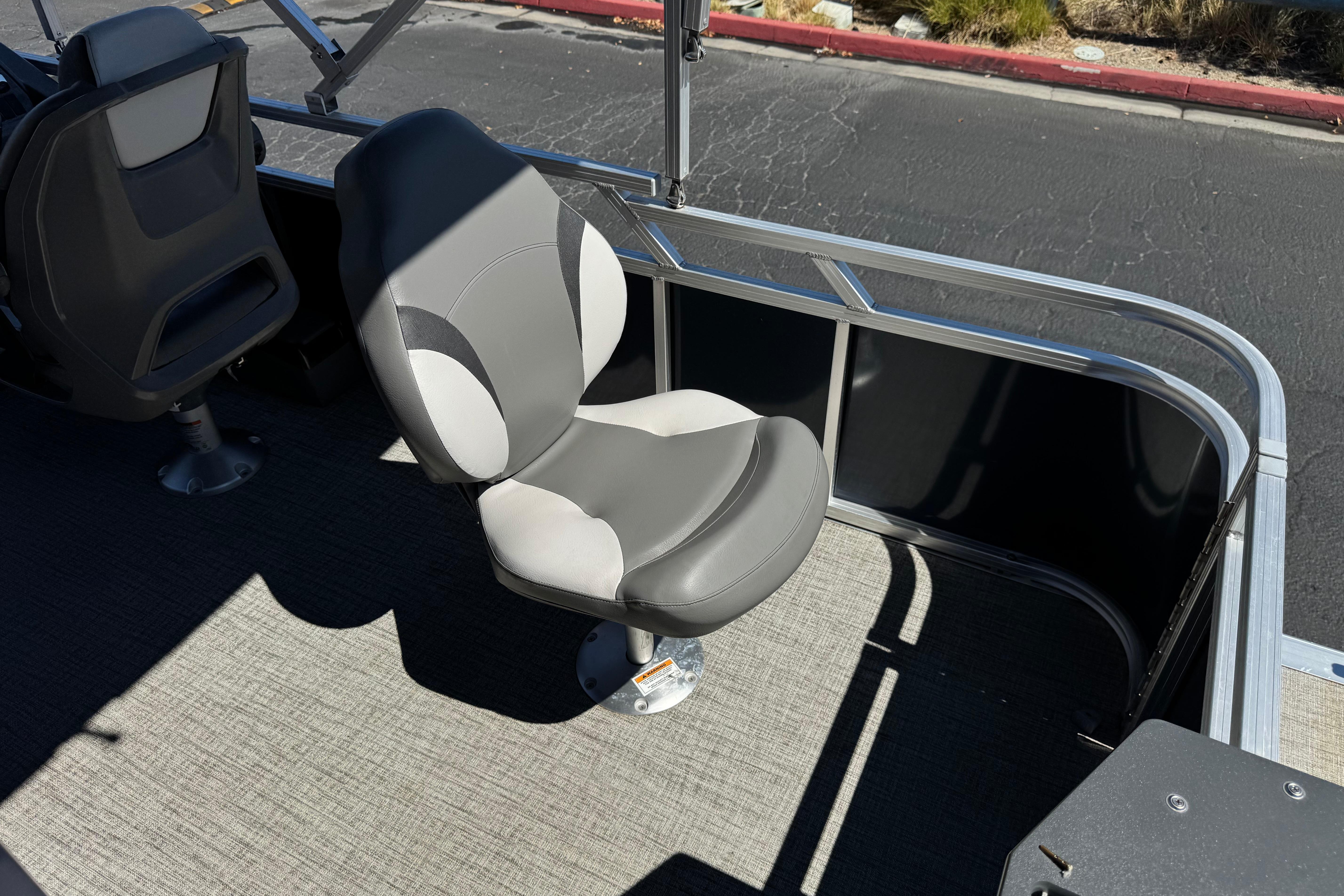 2023 Avalon Venture Fish N Cruise boat seat, gray and white, on deck.