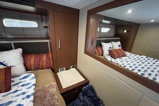Luxurious cabin interior of 2016 Sea Ray Sundancer 510 yacht with cozy bedding.