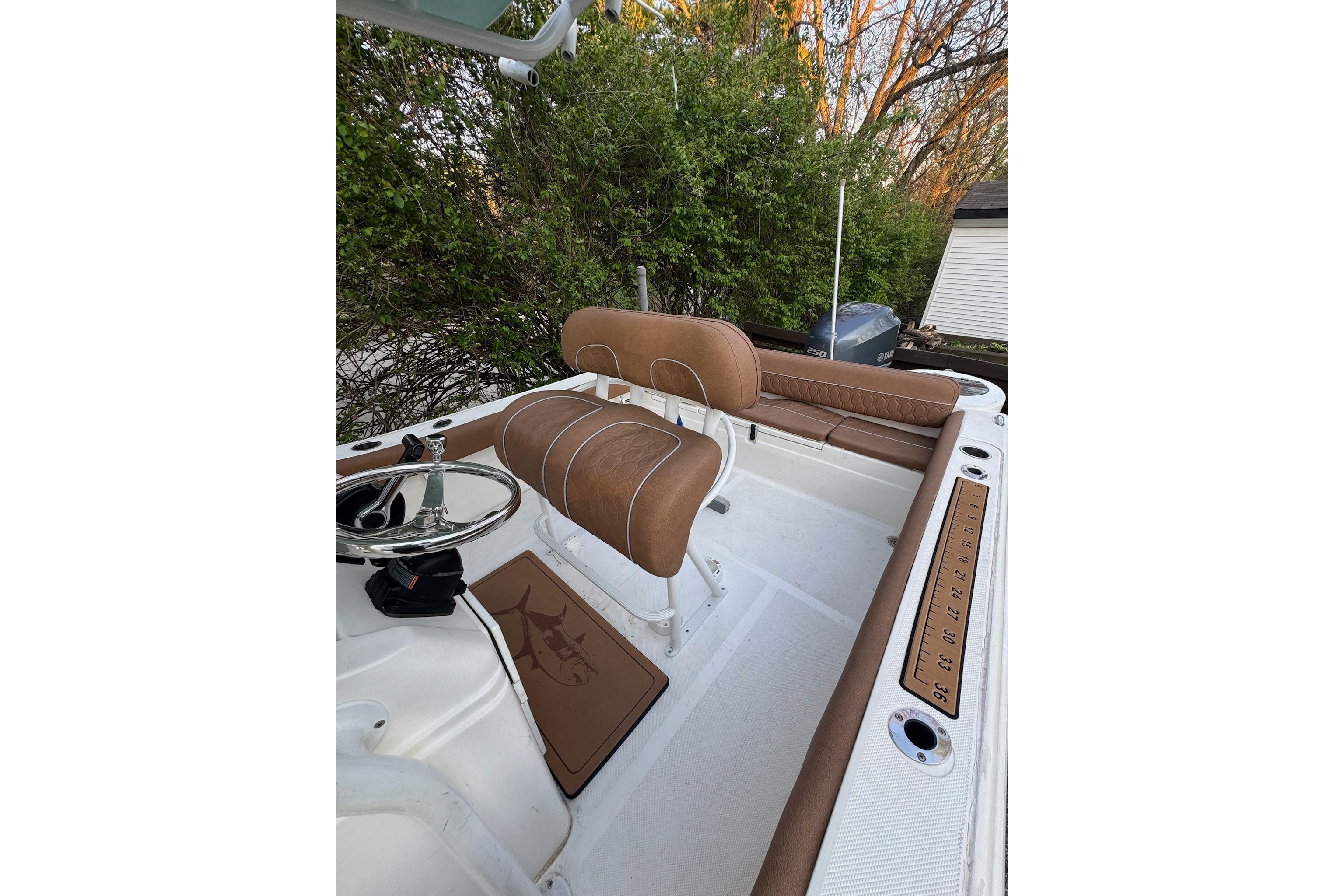 2013 Sea Fox 246 Commander boat interior with brown seating and steering wheel.