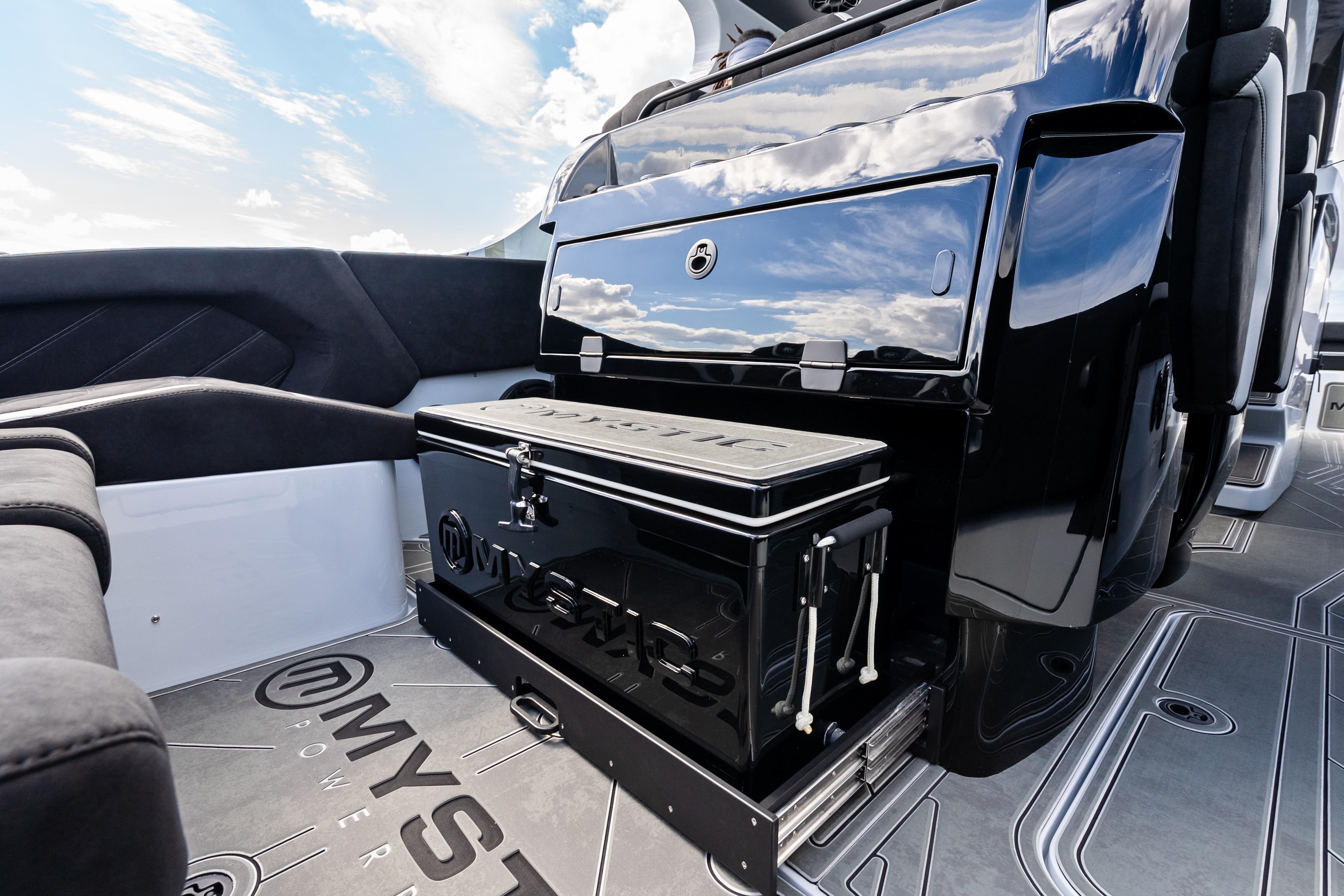 Interior of 2027 Mystic Powerboats M4200, featuring sleek black seating and storage.