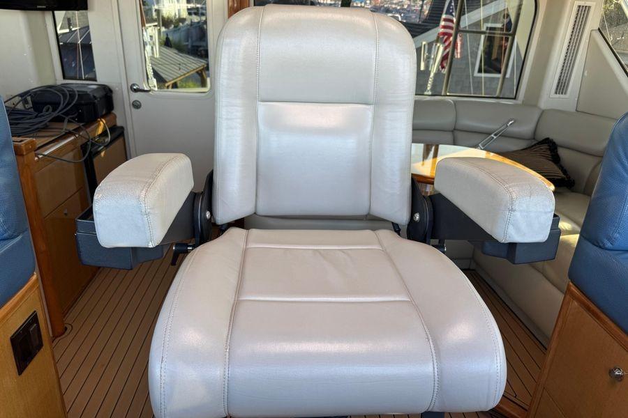 Captain's chair on 2002 Viking 61 Enclosed Bridge yacht interior.