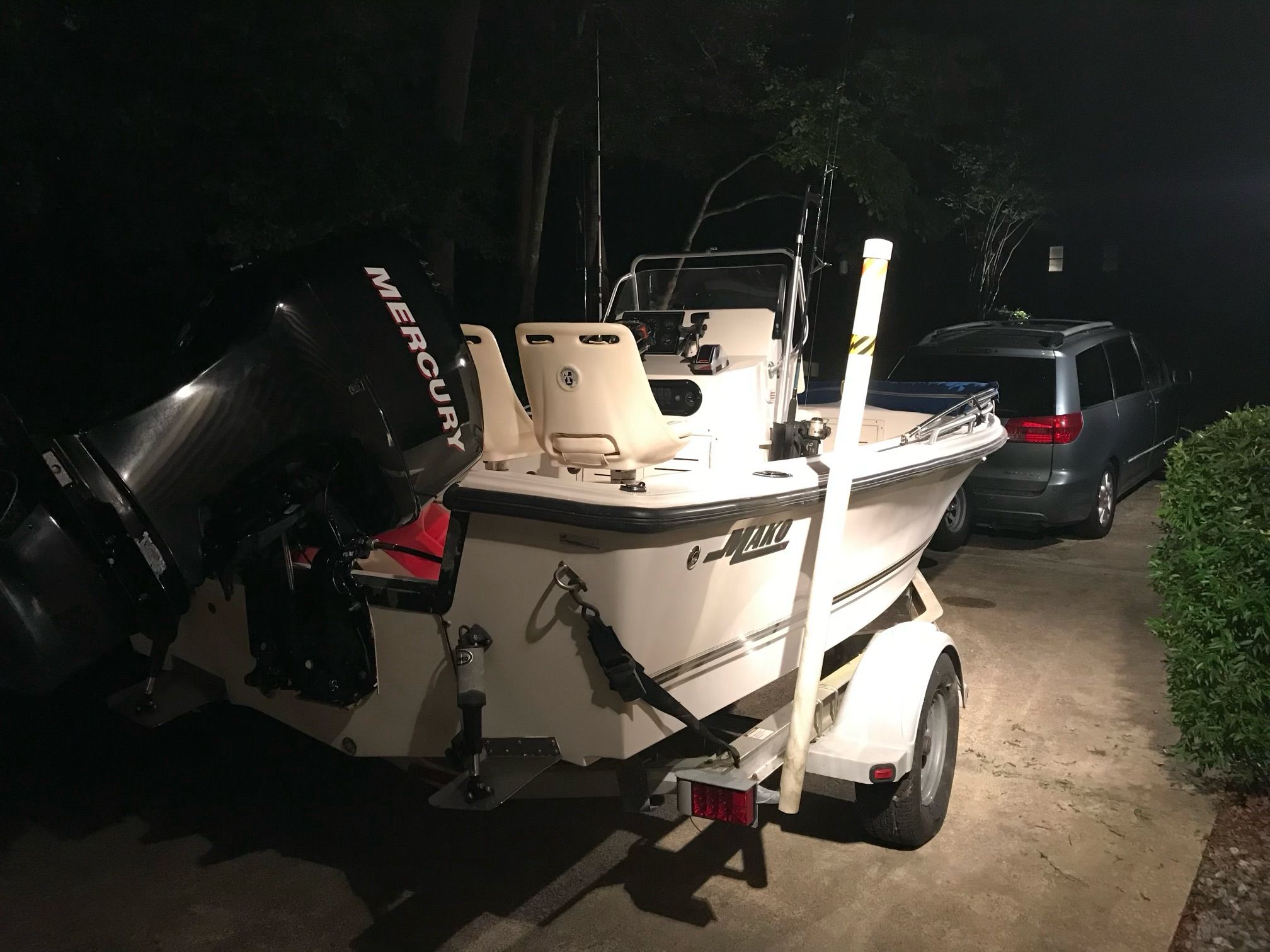 2006 Mako 171 Center Console boat on trailer at night.