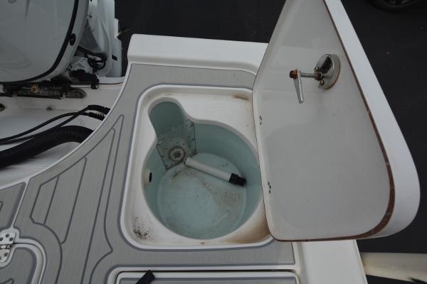 Open storage compartment on 2021 Sea Pro 228 Bay boat, featuring a circular interior.