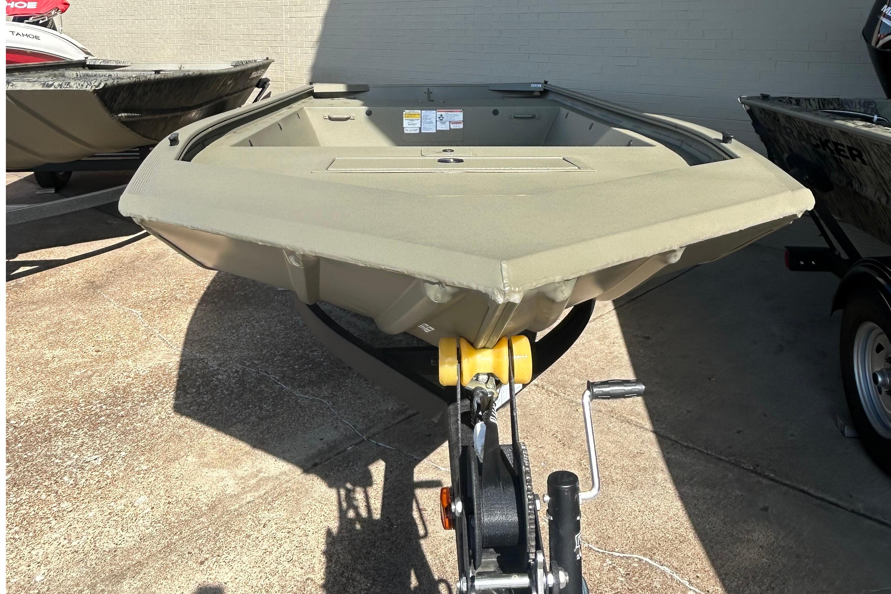 2026 Tracker Grizzly 1648 Utility boat on trailer, displayed outdoors.