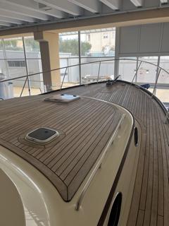 Luxury San Juan SJ 48 yacht, 2009 model, with sleek wooden deck in indoor setting.