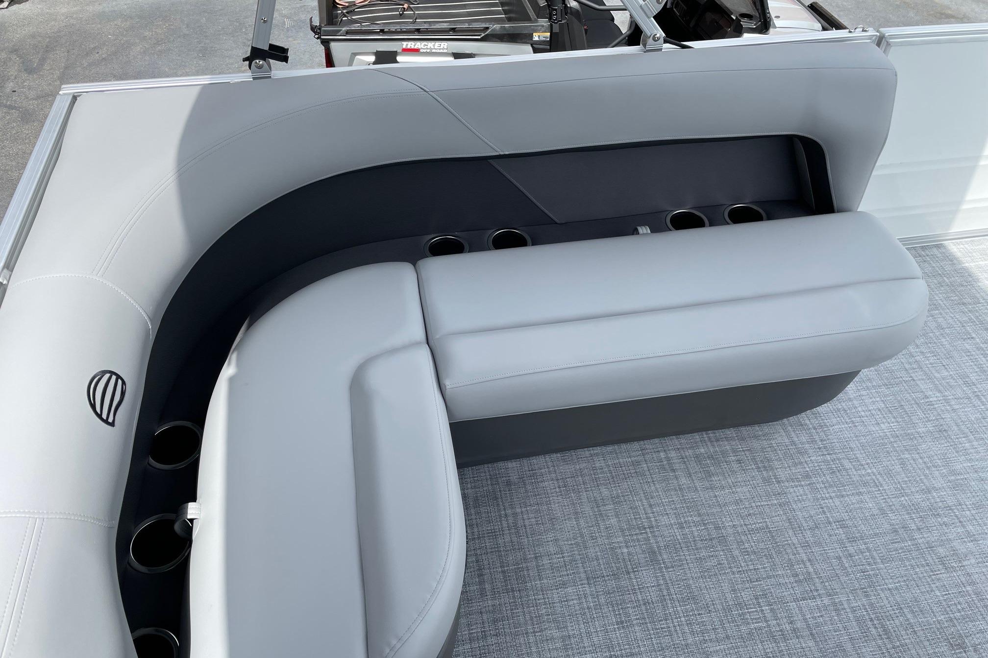 2026 Sun Tracker Party Barge 16 DLX interior seating with cup holders, gray upholstery.