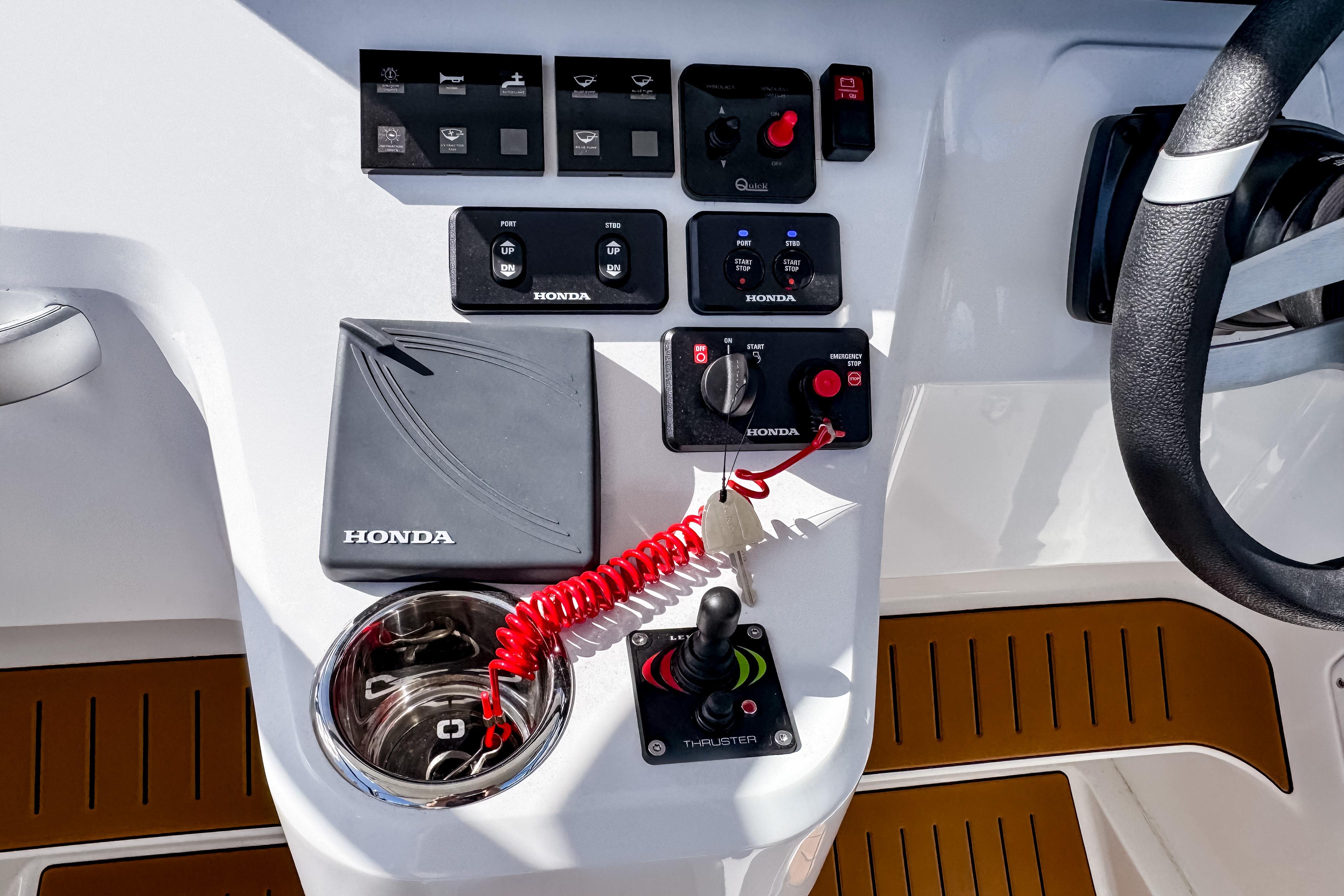Control panel of 2025 STERK 31 boat with Honda components and steering wheel.
