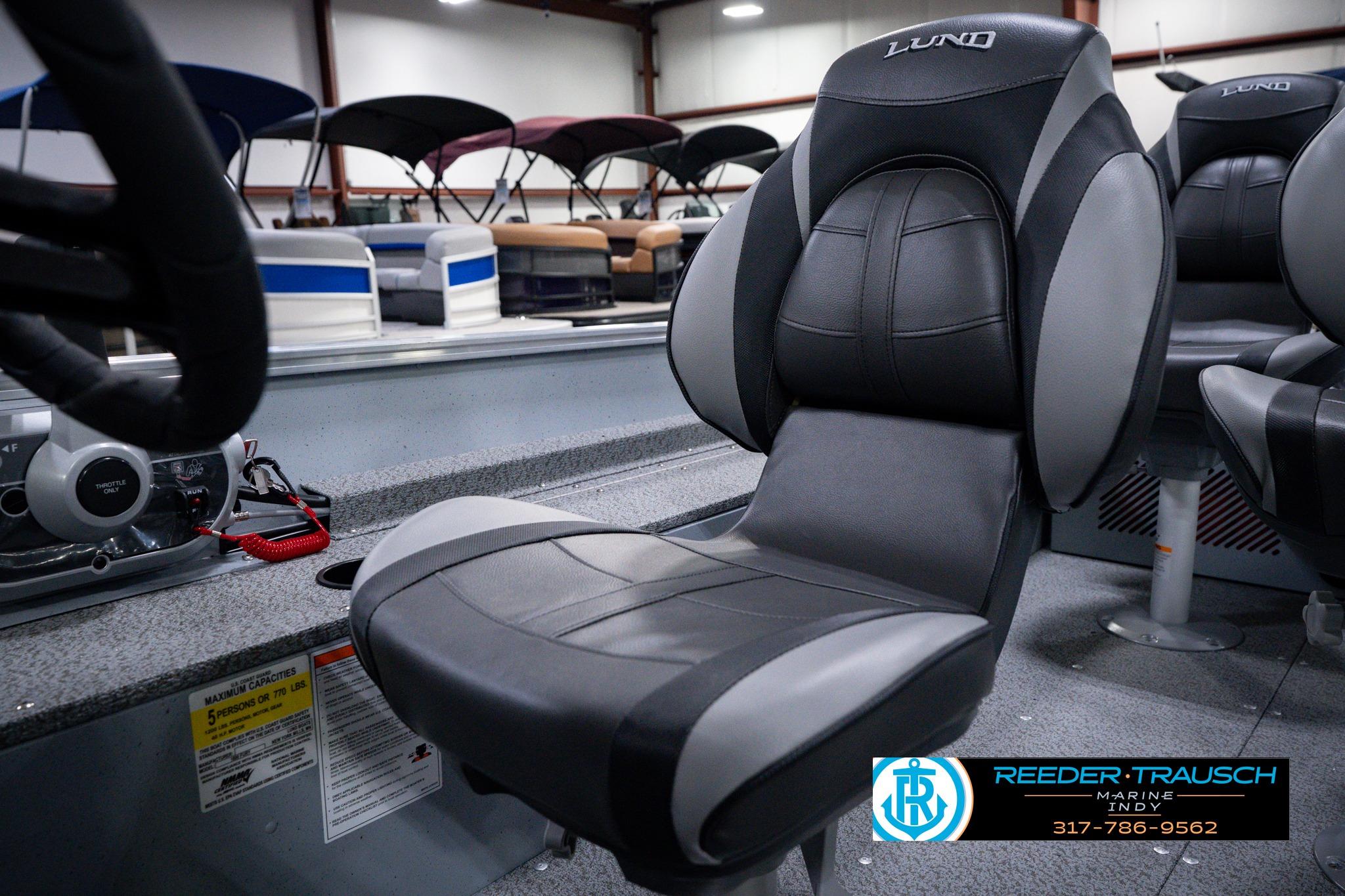 2026 Lund 1600 Fury SS boat interior with comfortable seating and modern dashboard controls.