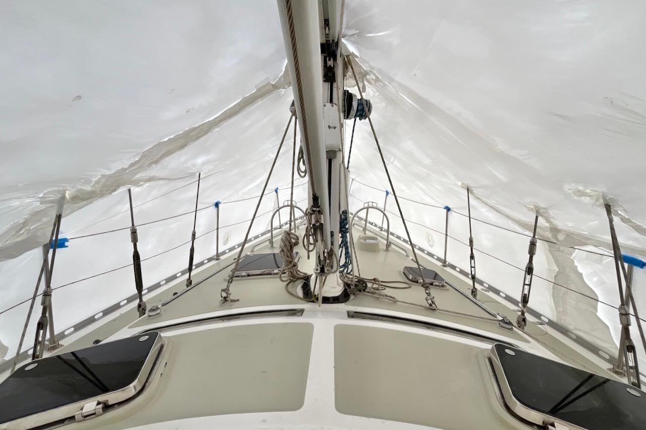 2004 Hylas 49 sailboat deck under protective cover, showcasing rigging and structure.