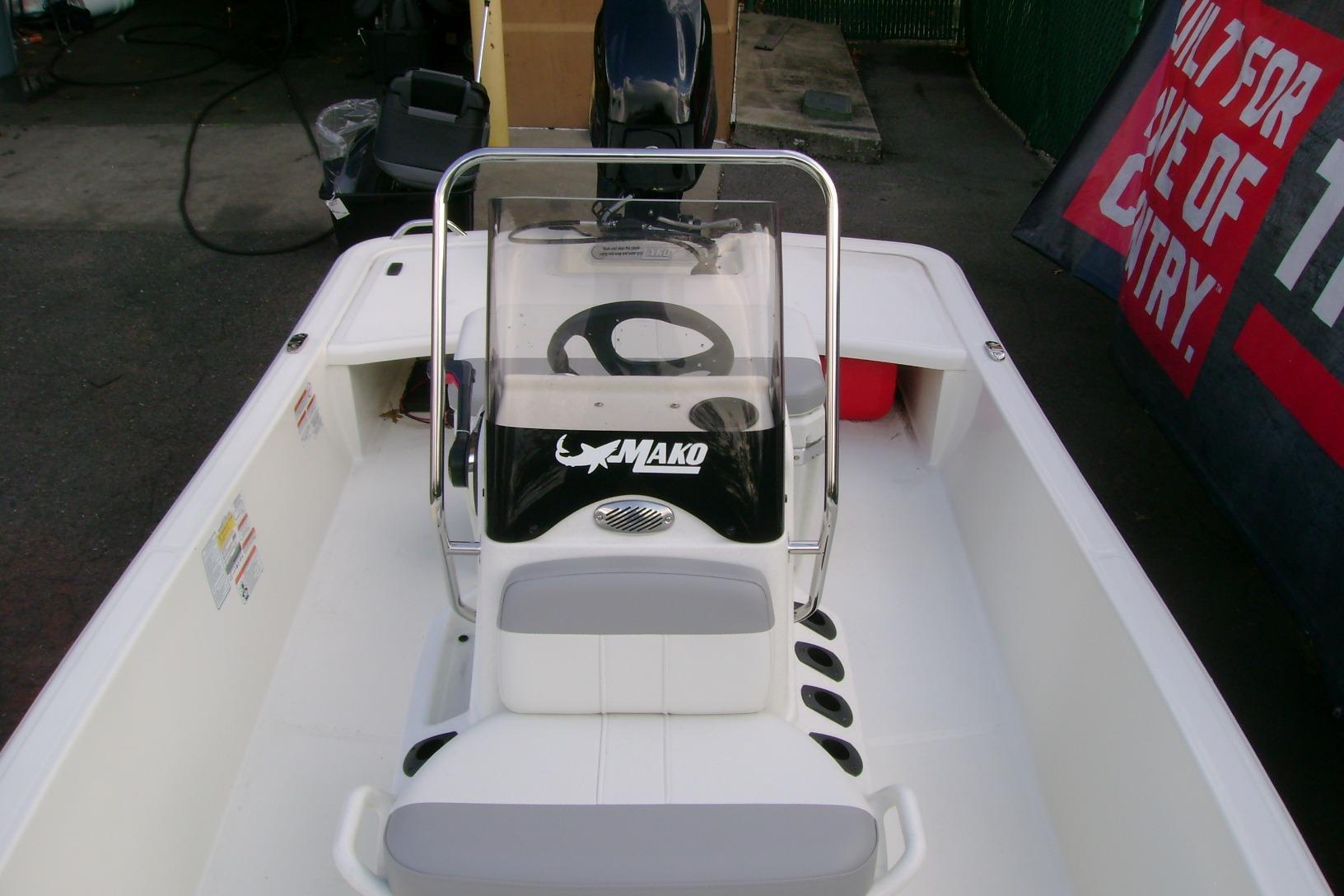 2026 Mako Pro Skiff 15 CC boat interior with steering console and seating.