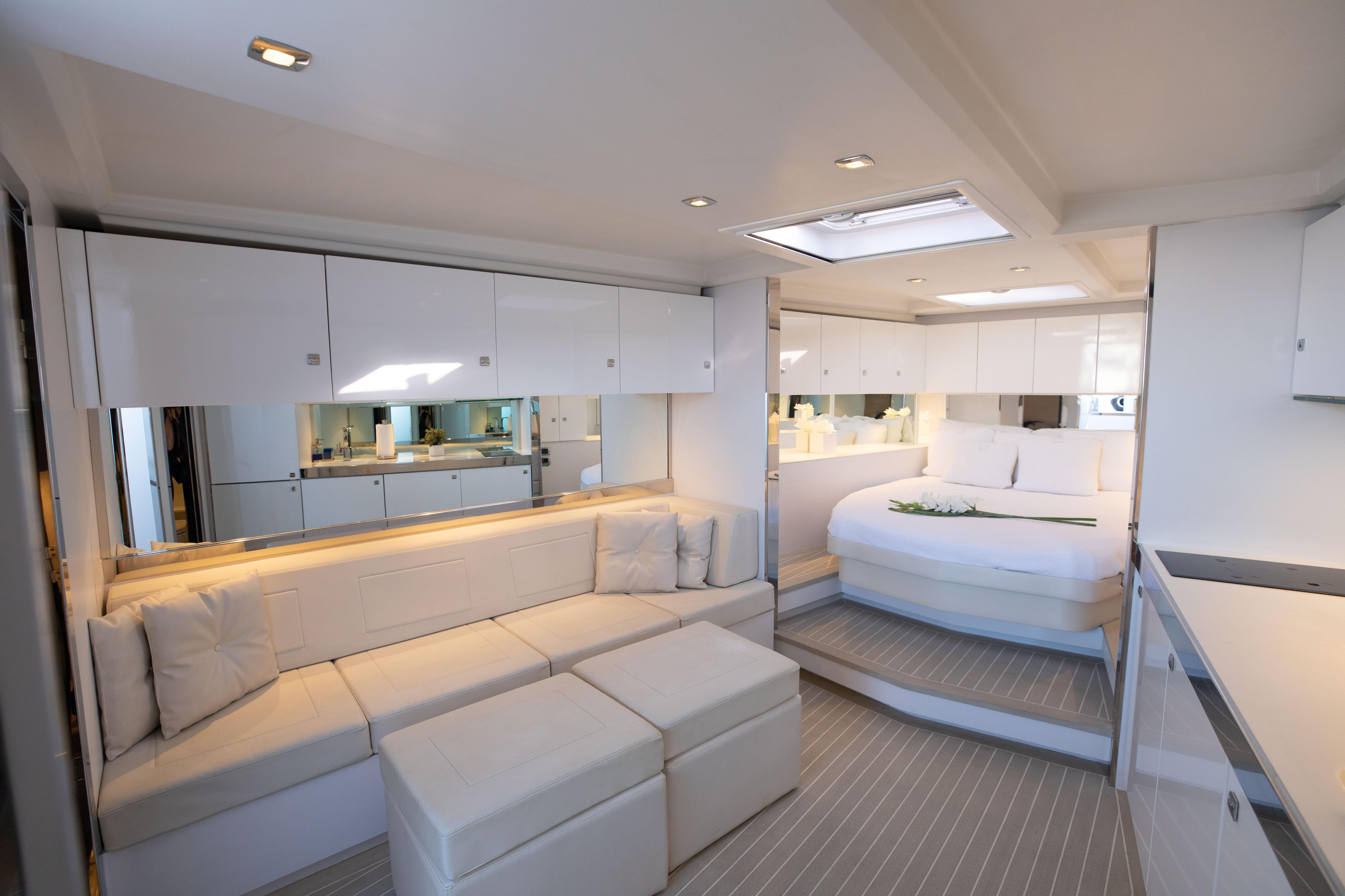 Luxurious interior of 2017 VanDutch 55 yacht with modern seating and bedroom.