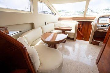 Luxurious interior of 2003 Azimut 74 Solar yacht with elegant seating and wooden accents.