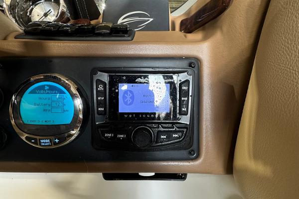 Dashboard of 2023 Crownline 215 XS boat with Bluetooth stereo system.