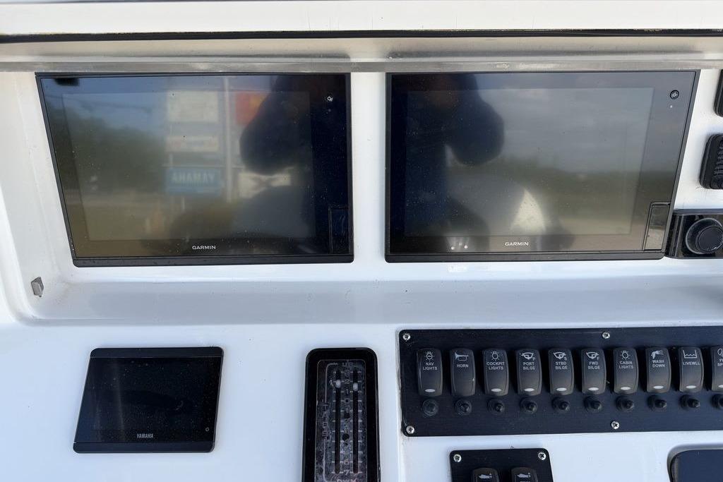 Control panel of 2004 Fountain Bluewater 34 CC with Garmin displays and switches.