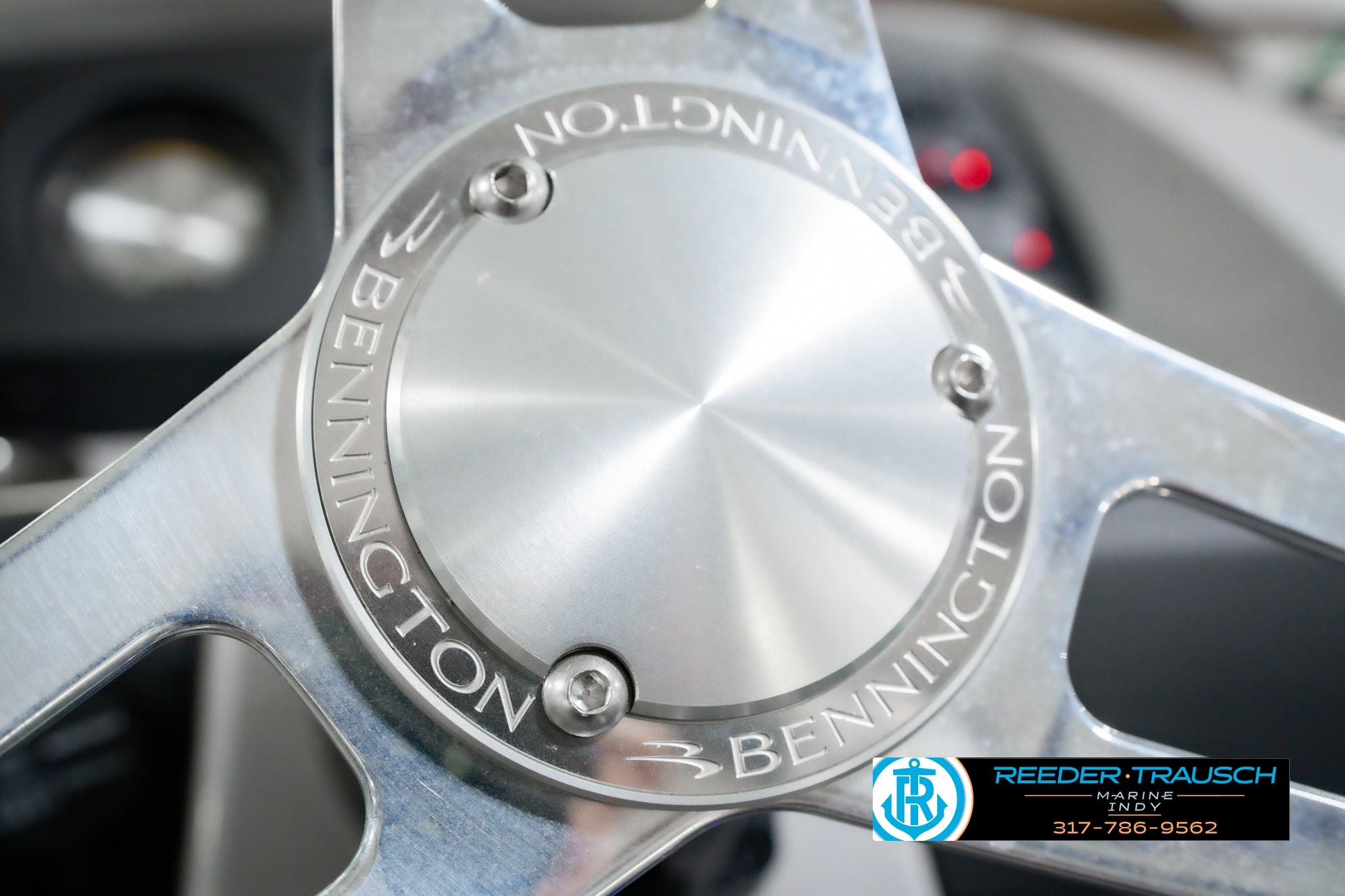 Close-up of 2026 Bennington 22 SXSAPG steering wheel with logo engraving.