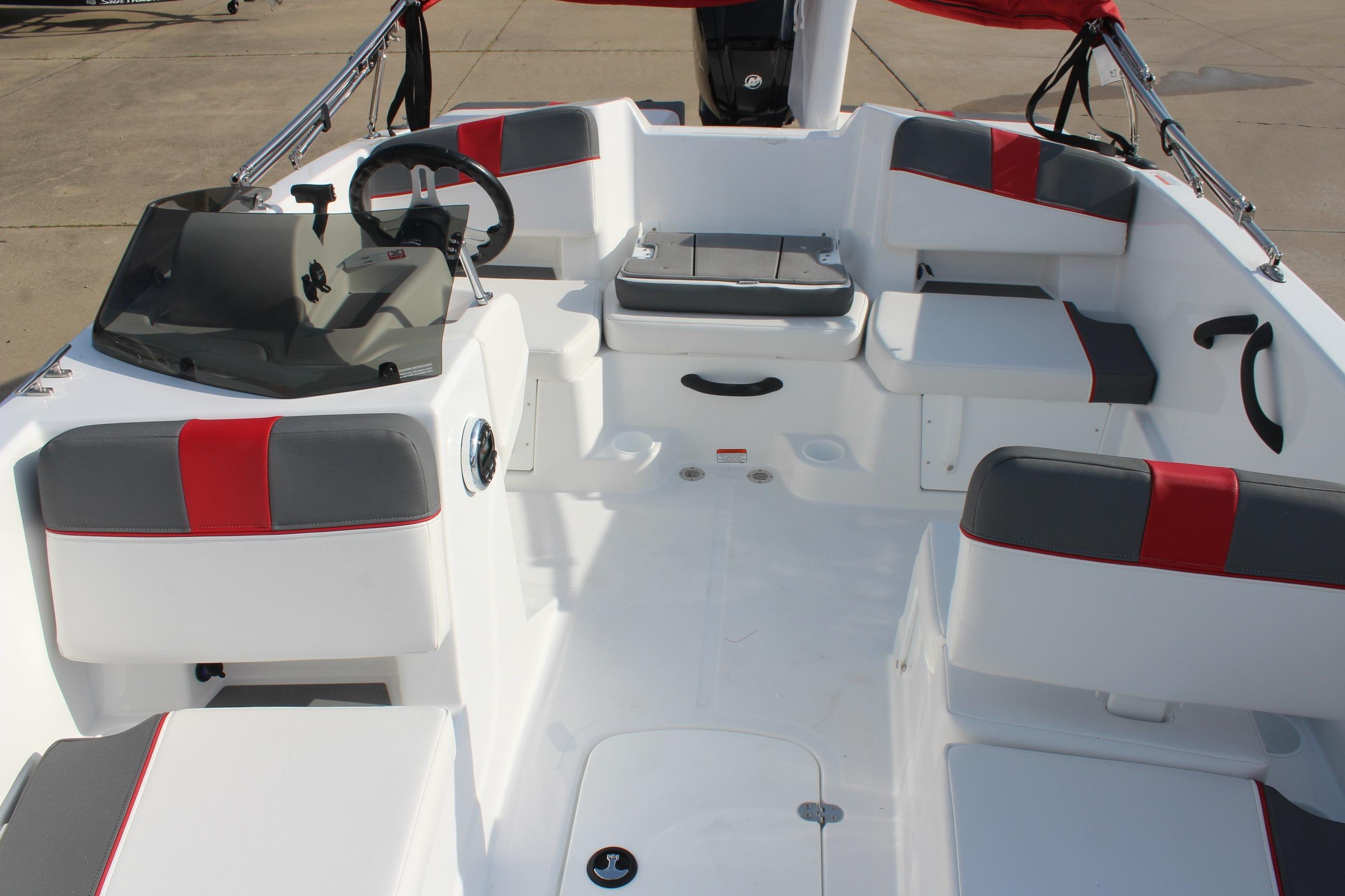 2026 Tahoe T18 boat interior with gray and red seating, steering wheel, and spacious layout.