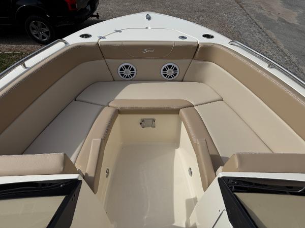 2025 Scout 215 Dorado boat interior with beige seating and speakers.