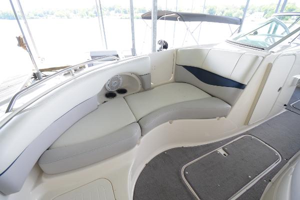 Interior view of a Bryant 255 boat with curved seating and carpeted floor.