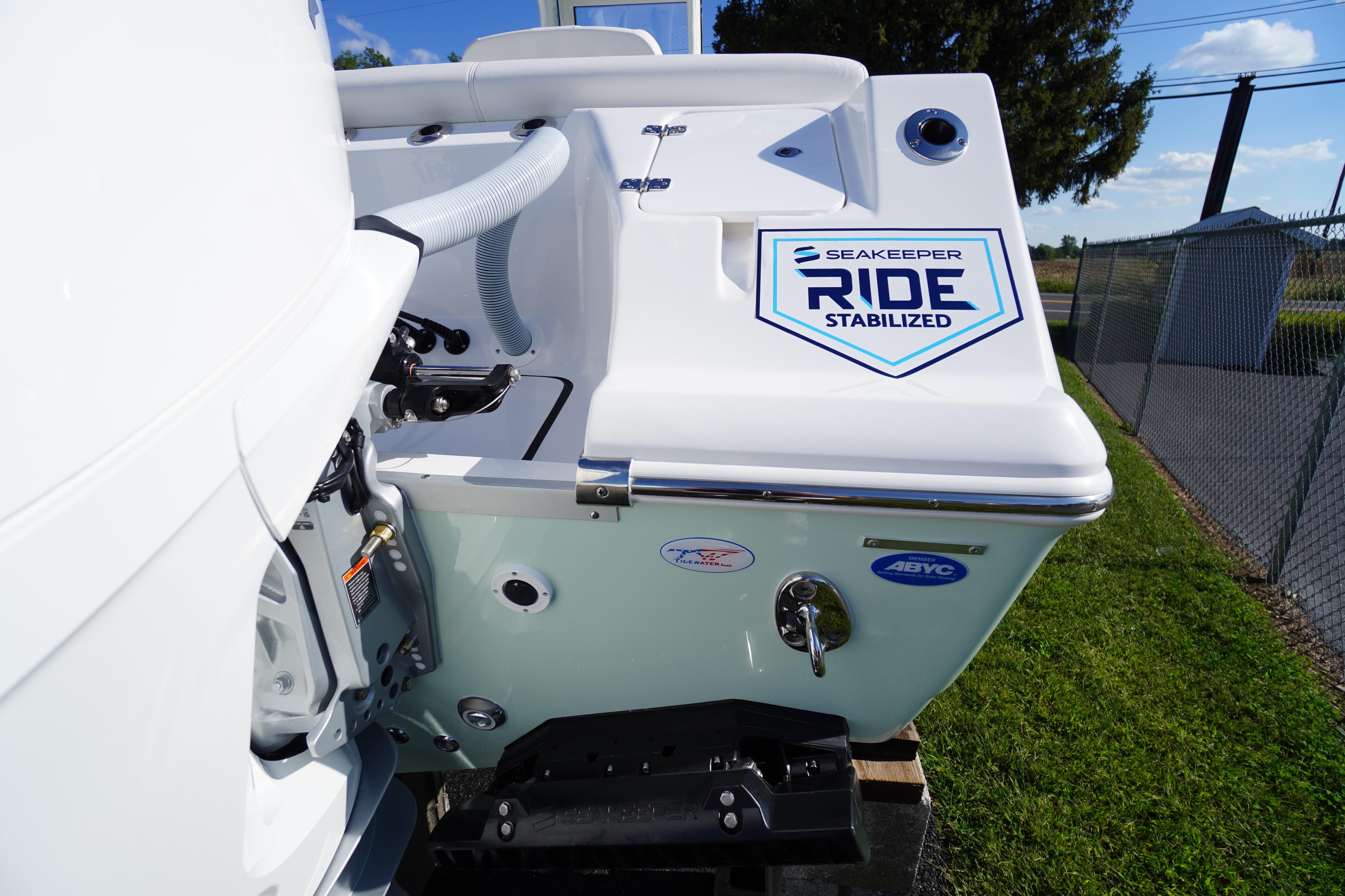 2026 Tidewater 272 LXF boat with Seakeeper Ride stabilization system, docked outdoors.