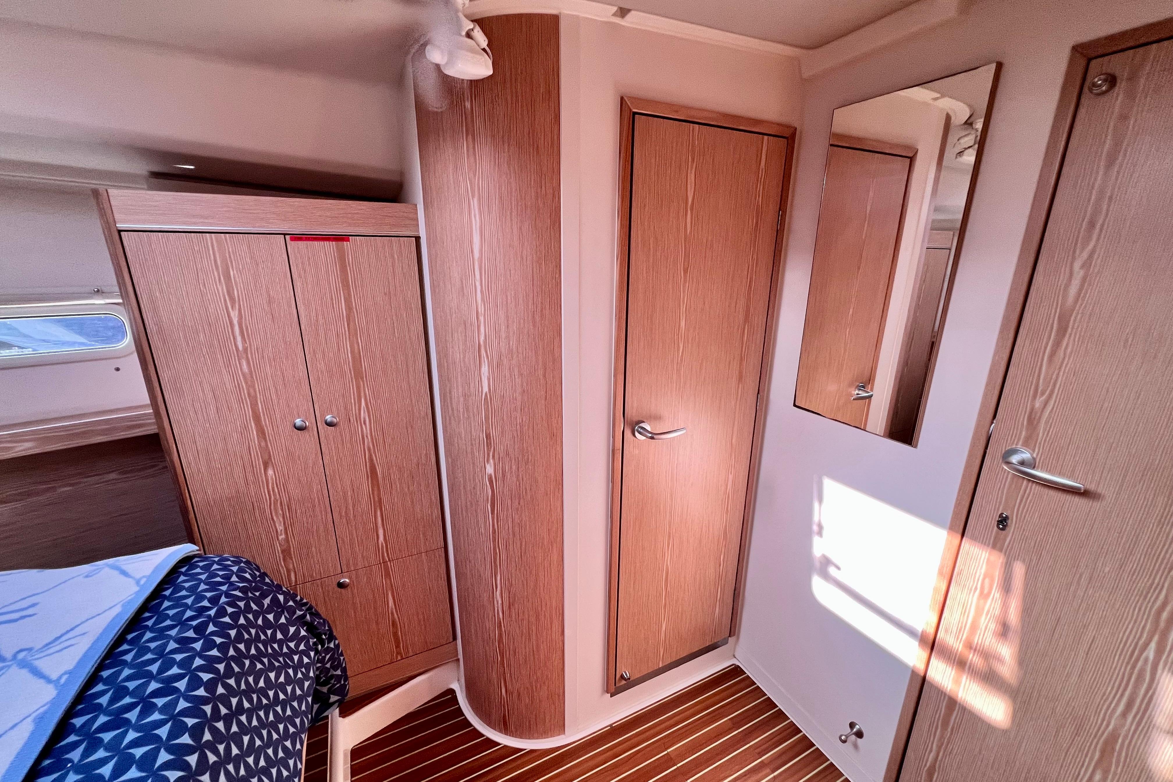 Interior of 2016 Hanse 455 yacht with wooden cabinetry and modern design.