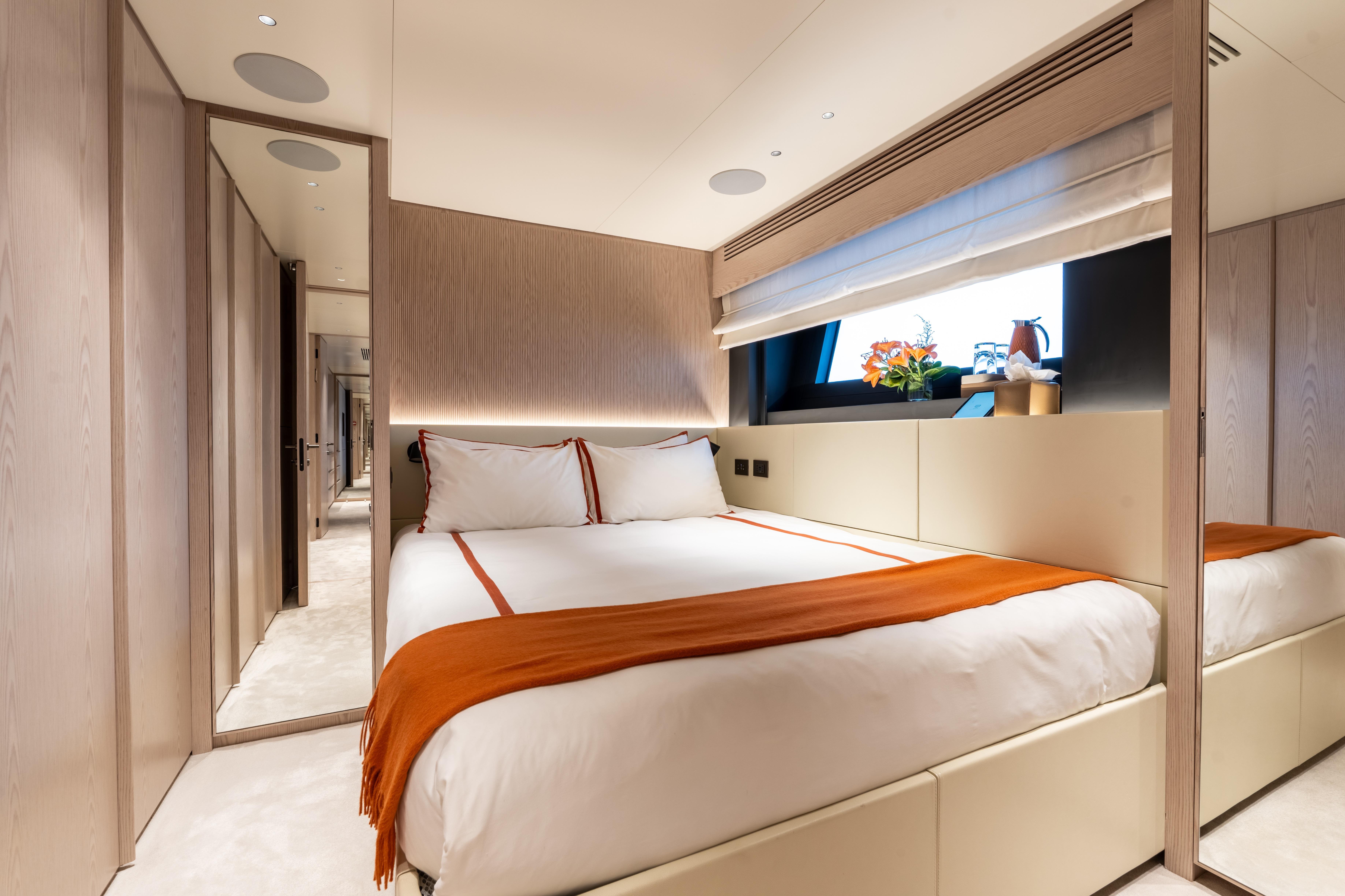 Luxurious bedroom interior on 2024 Benetti Oasis yacht, featuring elegant design and cozy ambiance.