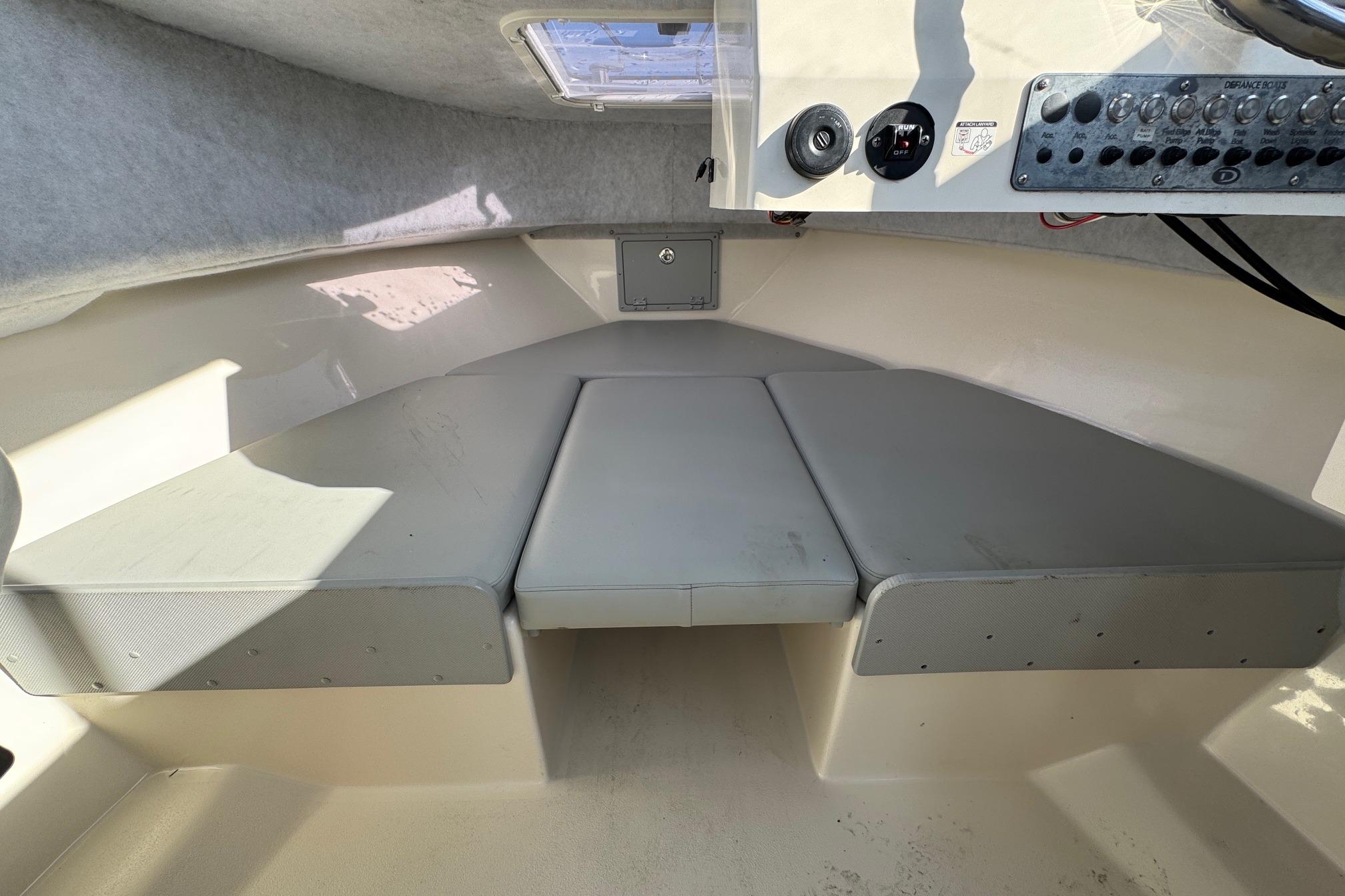 2023 Defiance Admiral 220 EX cabin interior with cushioned seating and control panel.