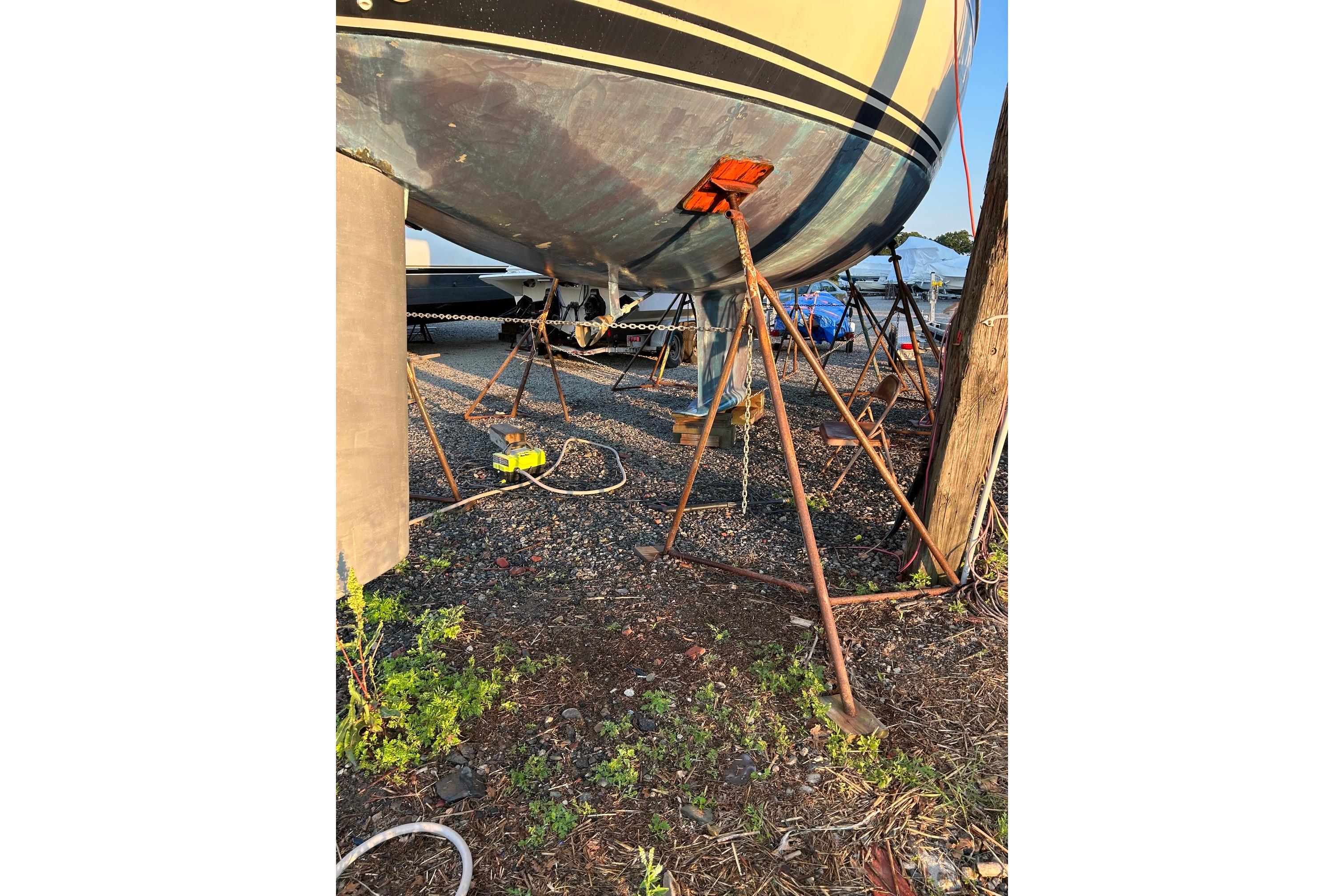 1987 Ericson 38-200 sailboat on stands, undergoing maintenance in a boatyard.