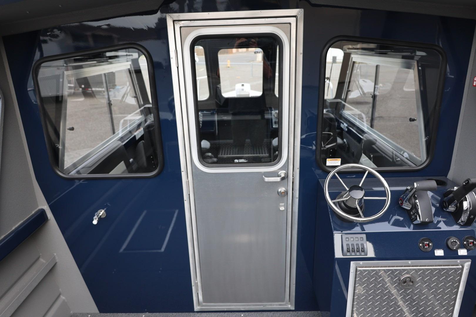 Interior view of 2026 Thunder Jet 24 Alexis Pro boat cockpit with steering wheel and controls.