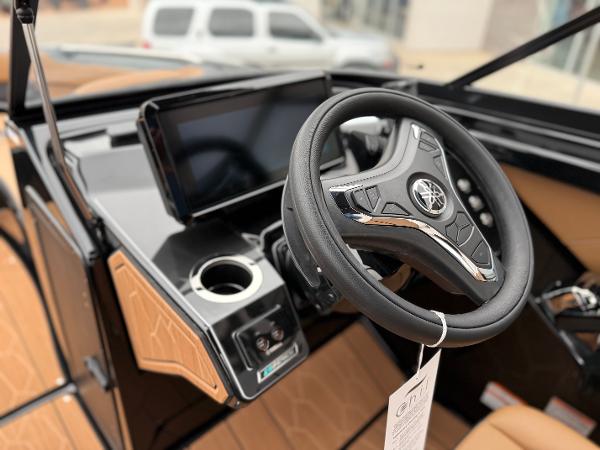 2025 Yamaha Boats 255XD steering wheel and dashboard, featuring modern controls and sleek design.