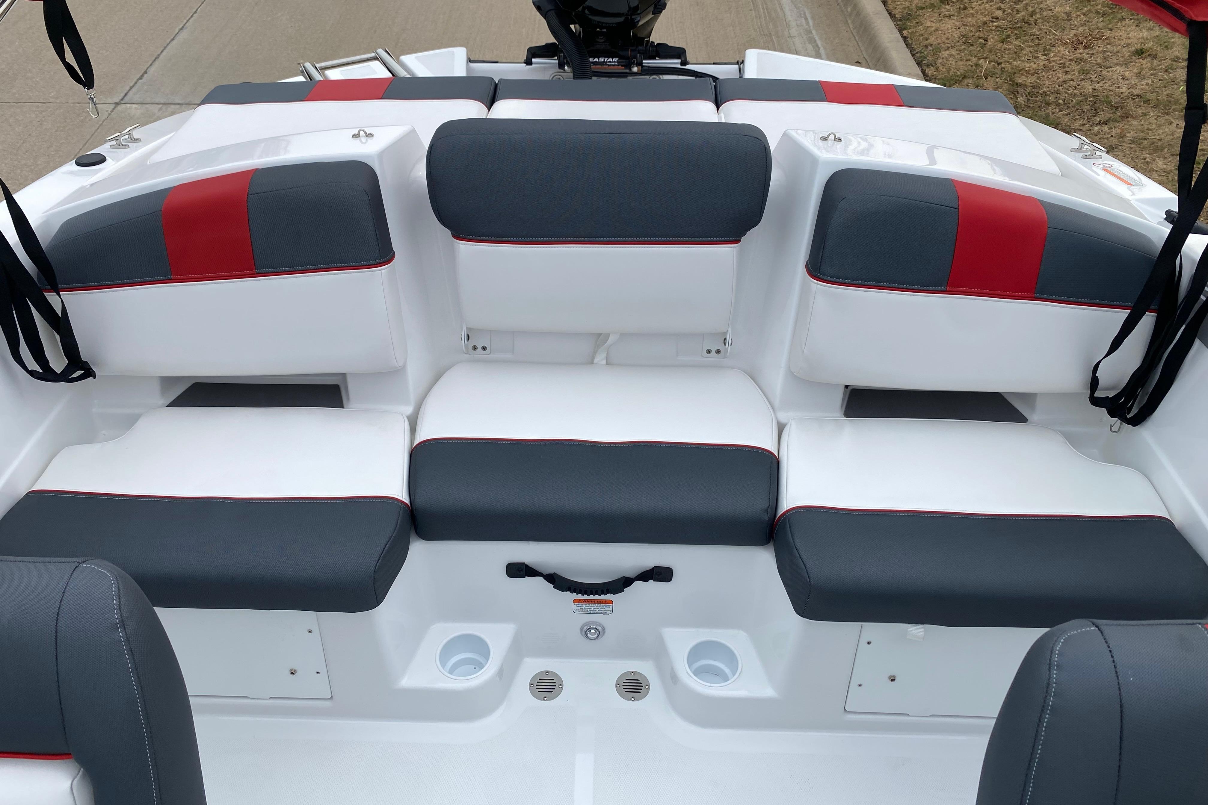 2026 Tahoe T21 boat interior with gray and red cushioned seating.