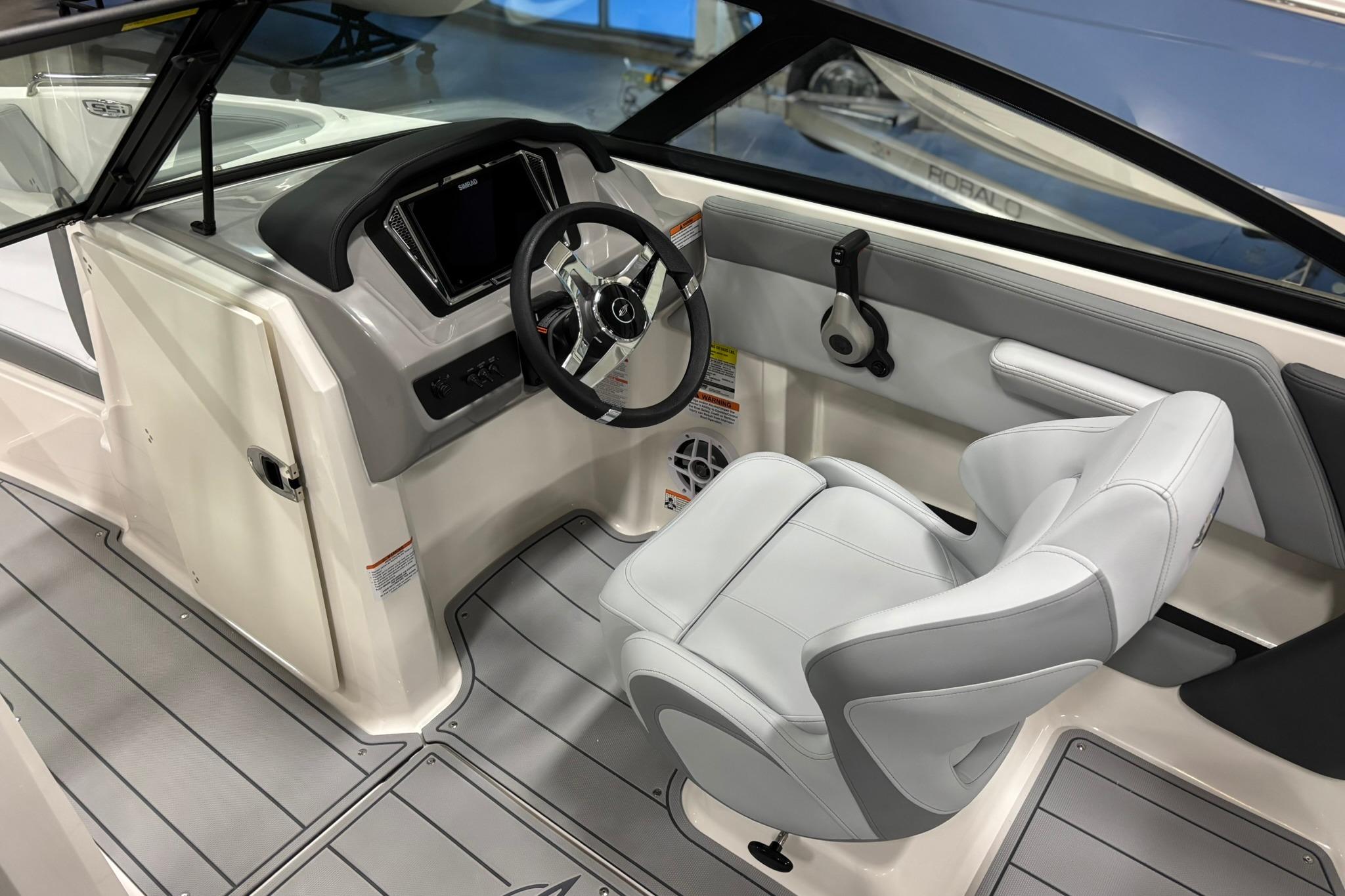 2026 Chaparral 21 SSi OB boat interior with modern steering and seating.