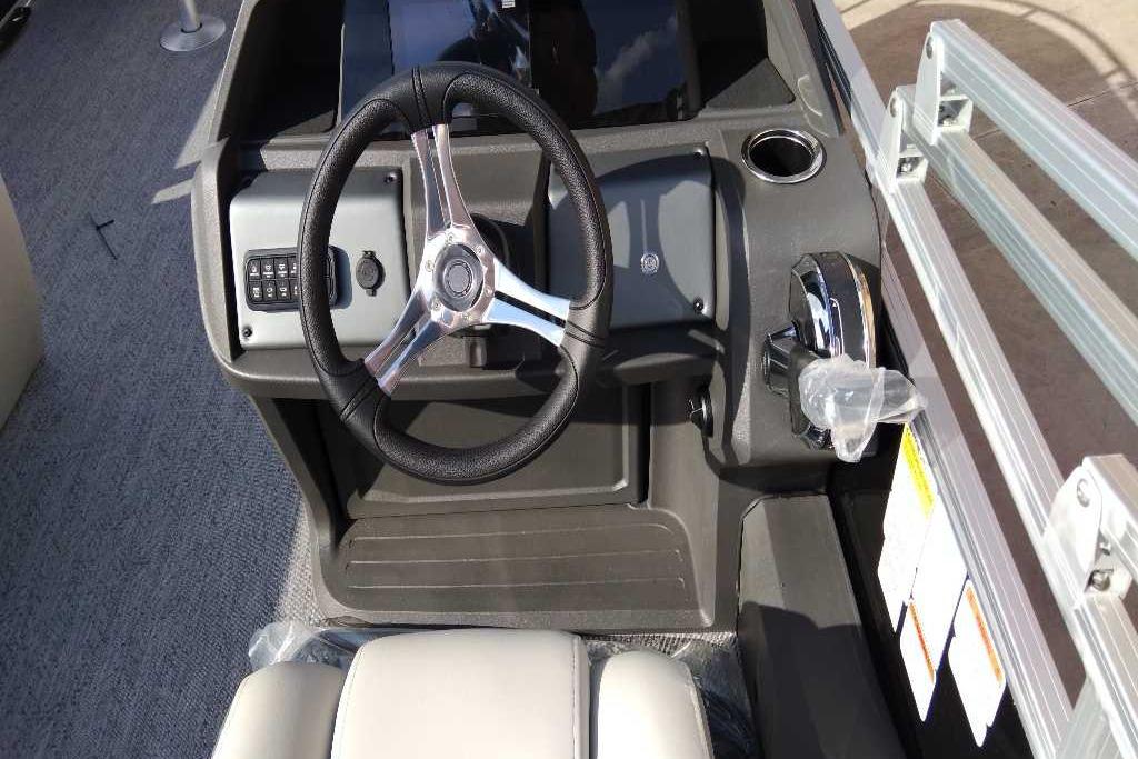 2026 Sun Tracker Fishin' Barge 22 DLX steering console with modern controls and cup holder.