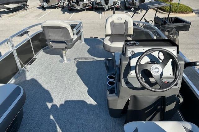 2026 Sun Tracker Bass Buggy 16 XL Select pontoon boat interior with steering console and seating.