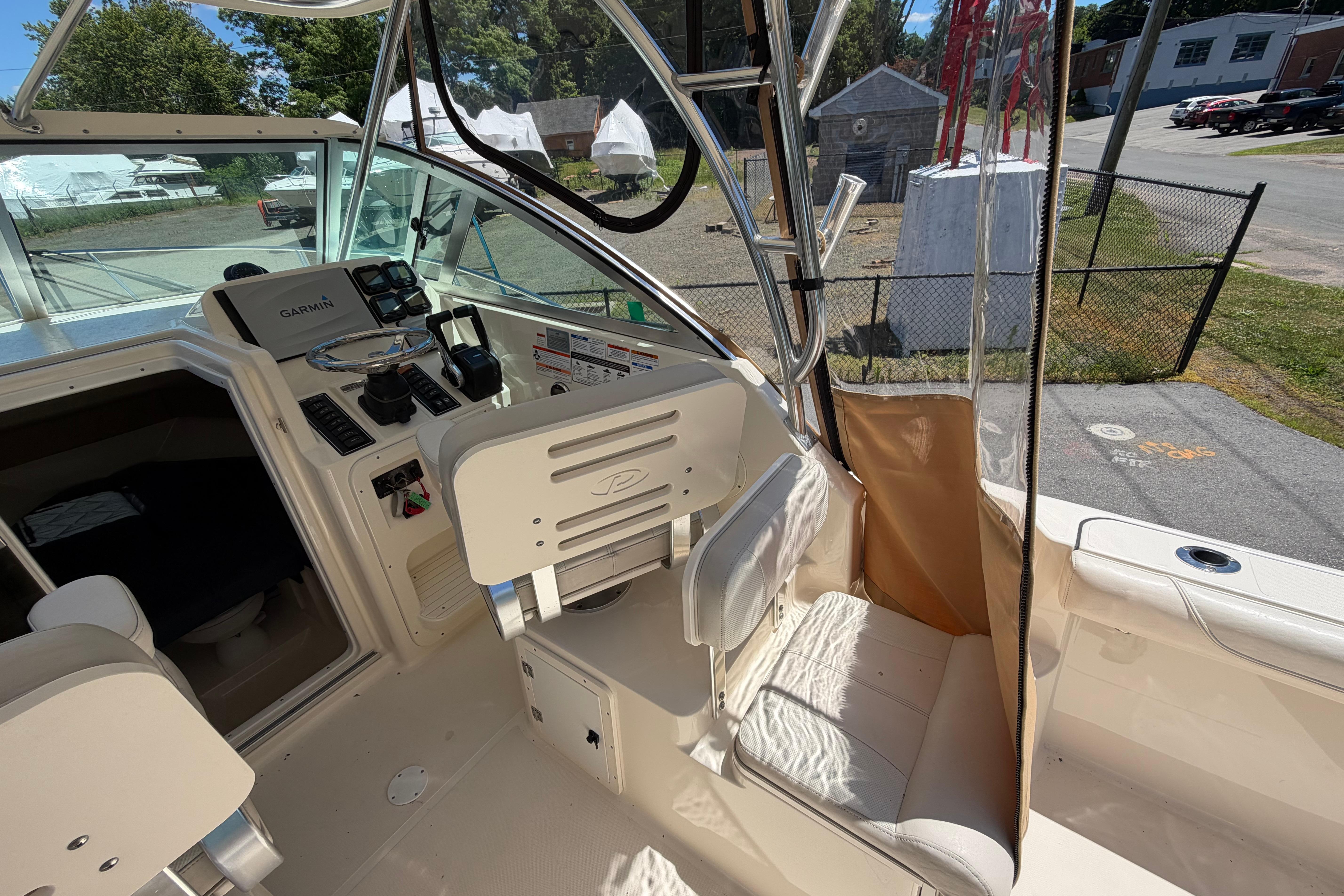 2010 Pursuit OS 255 Offshore boat interior with Garmin navigation system and seating.