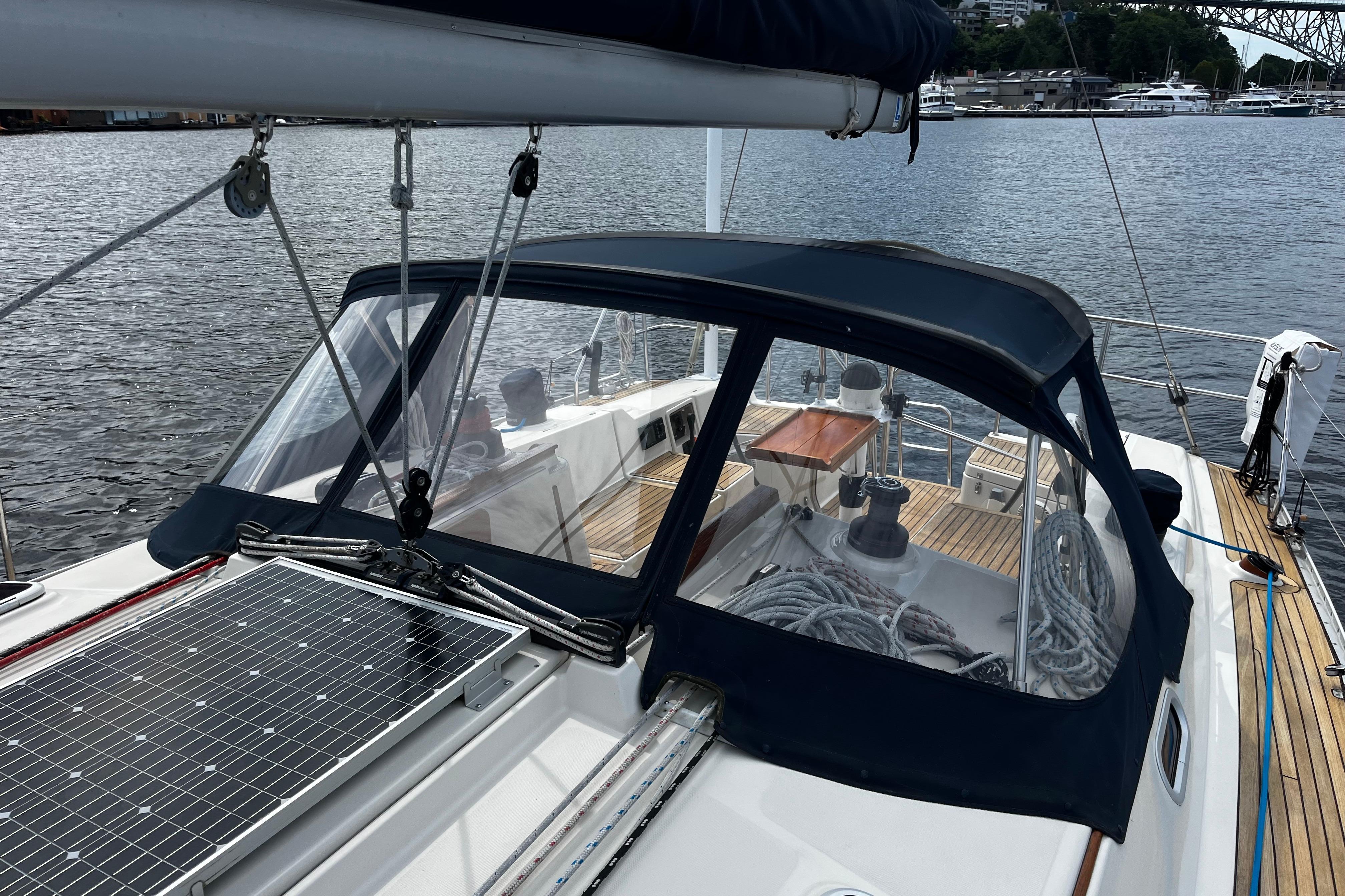 2004 Hanse 411 sailboat with solar panel and cockpit cover, docked by the water.