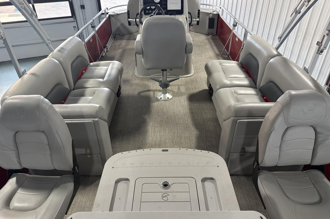 Interior of 2022 Landau ALURE 232 pontoon boat with gray seating and steering console.