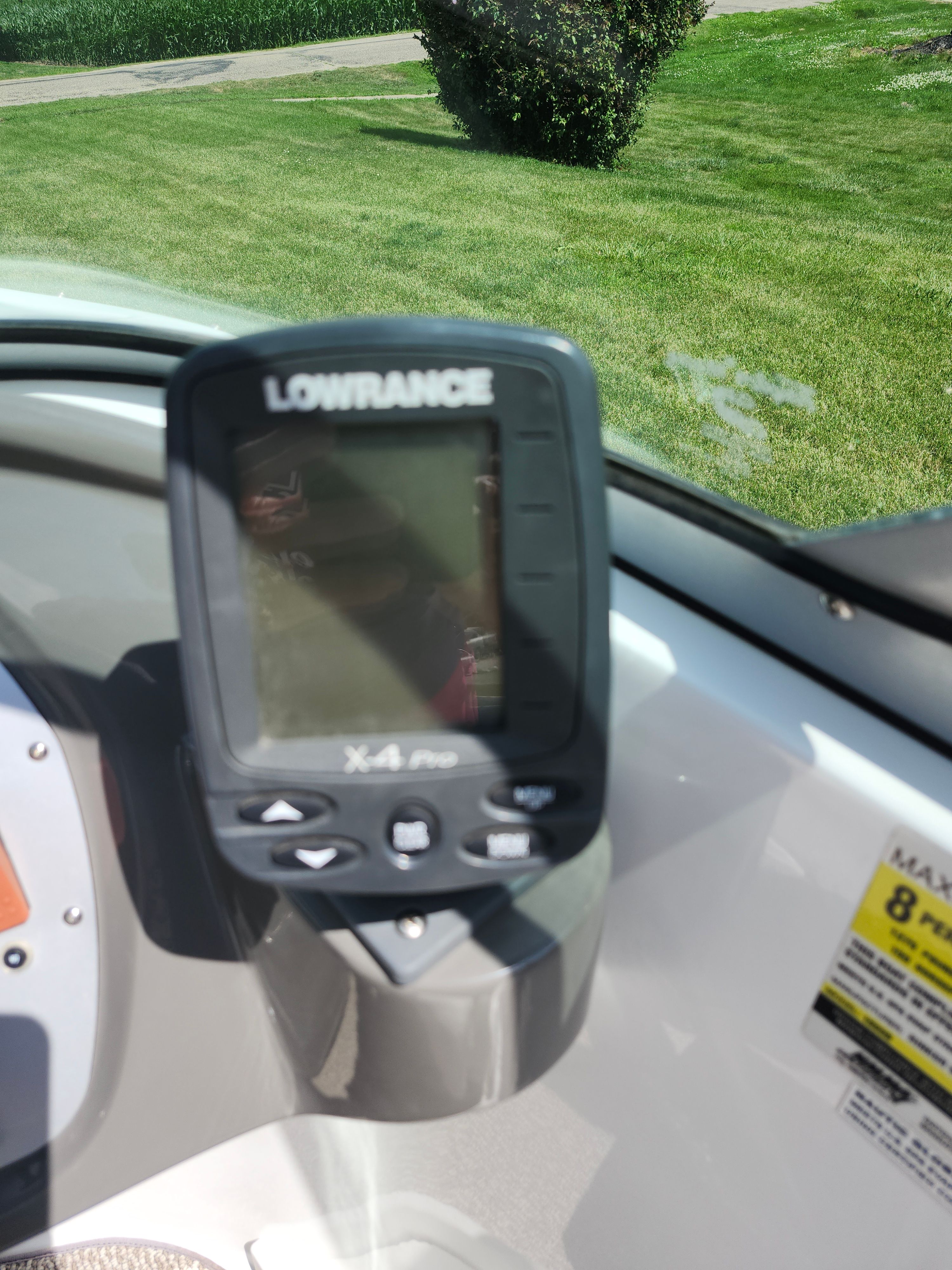A Lowrance X-4 Pro fish finder is mounted on a boat.
