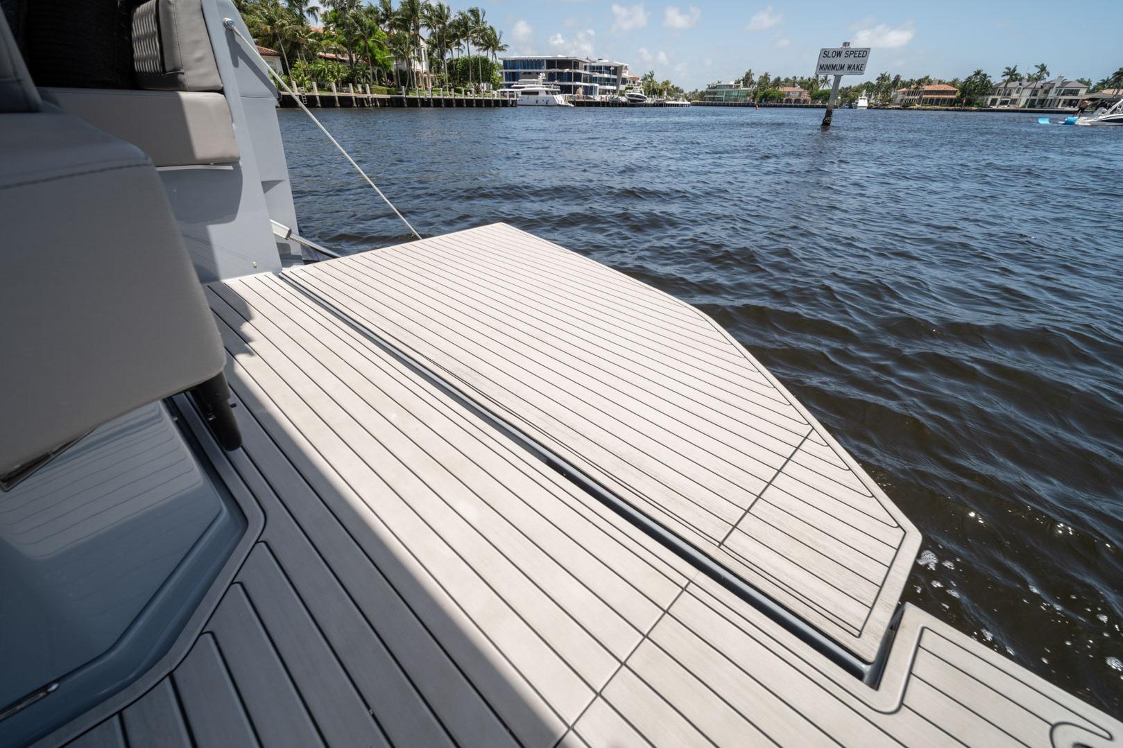 Luxury yacht deck on water, Hanover 387, 2026 model, sunny day, waterfront view.