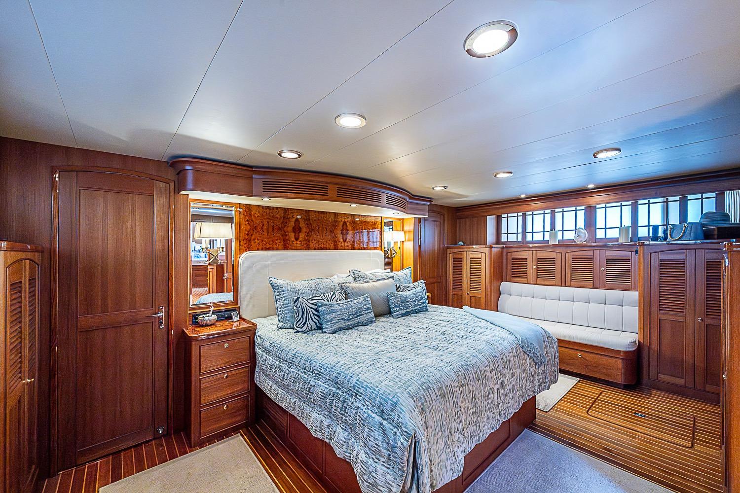Luxurious cabin interior of 2014 Marlow 80 Explorer yacht with elegant wood finishes.
