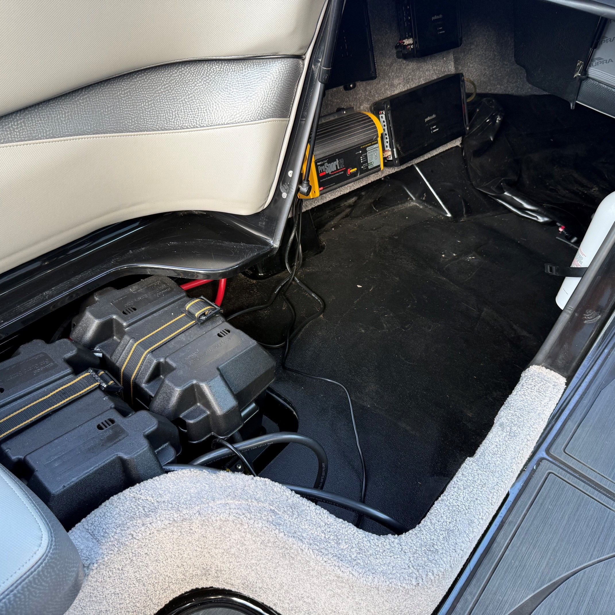 Interior of a 2014 Supra SC350 with batteries and electronics.