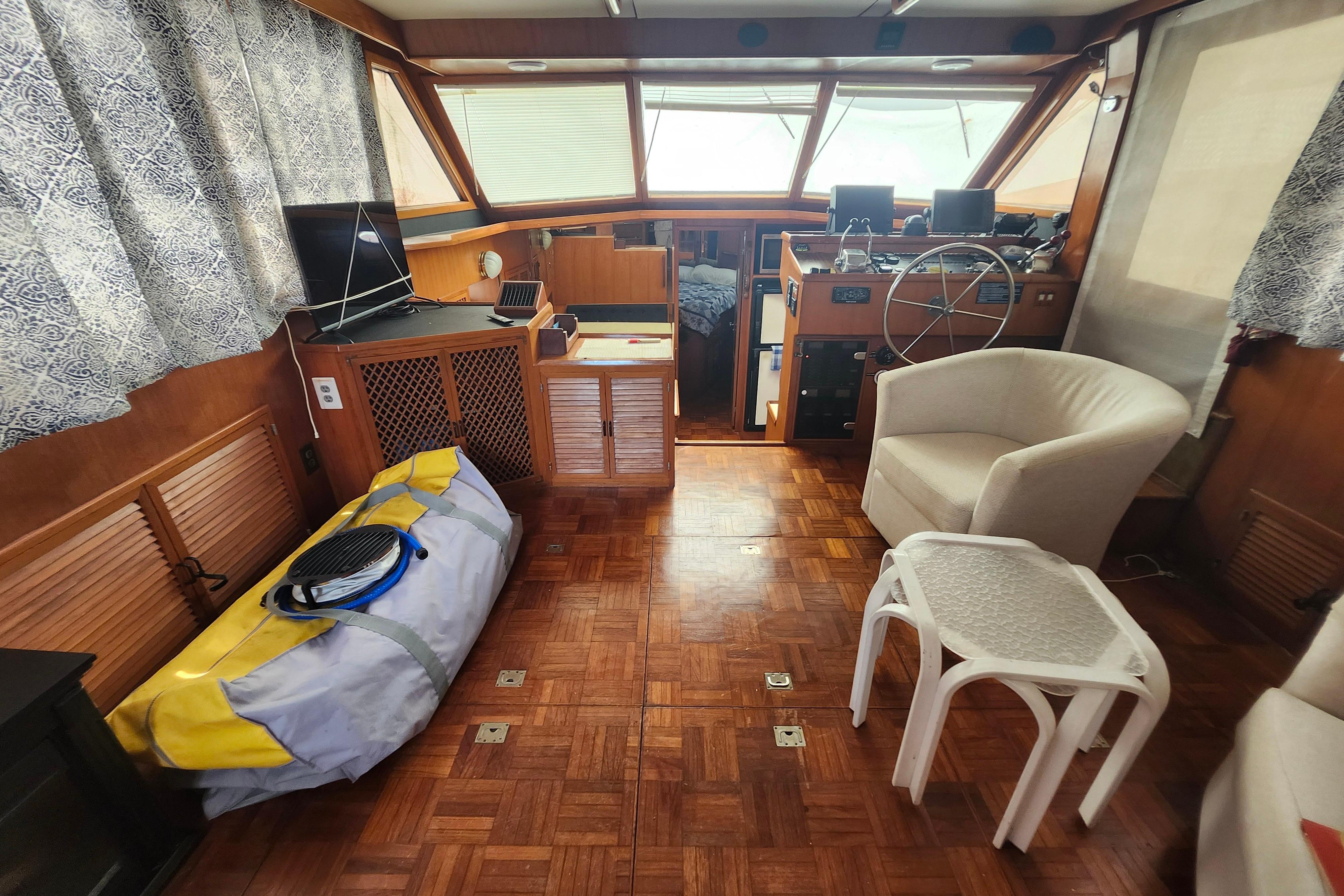 Interior of 1988 Marine Trader 43 yacht with helm, seating, and nautical equipment.