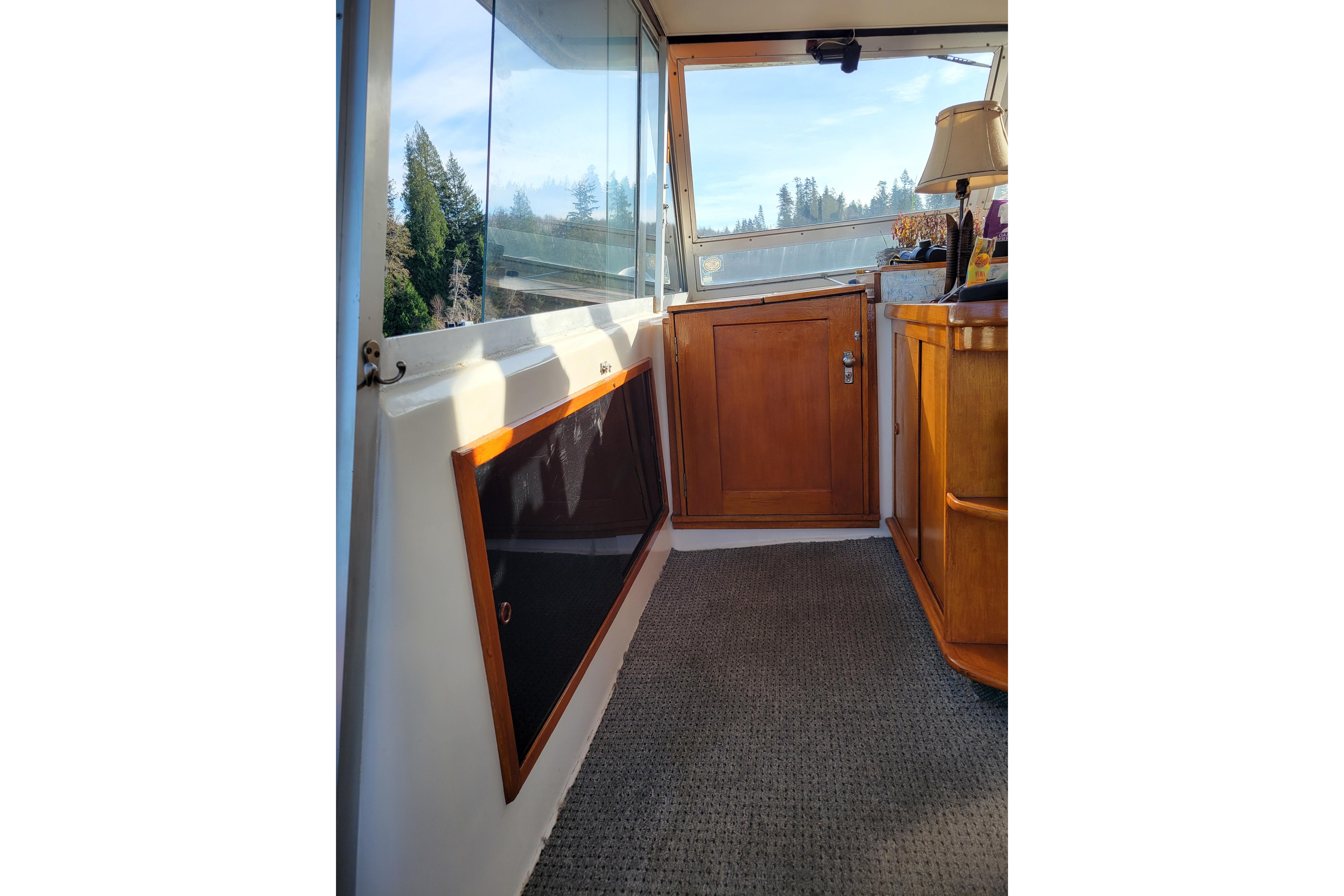Interior view of 1977 Pacemaker 40 Motor Yacht with wooden cabinetry and carpeted floor.