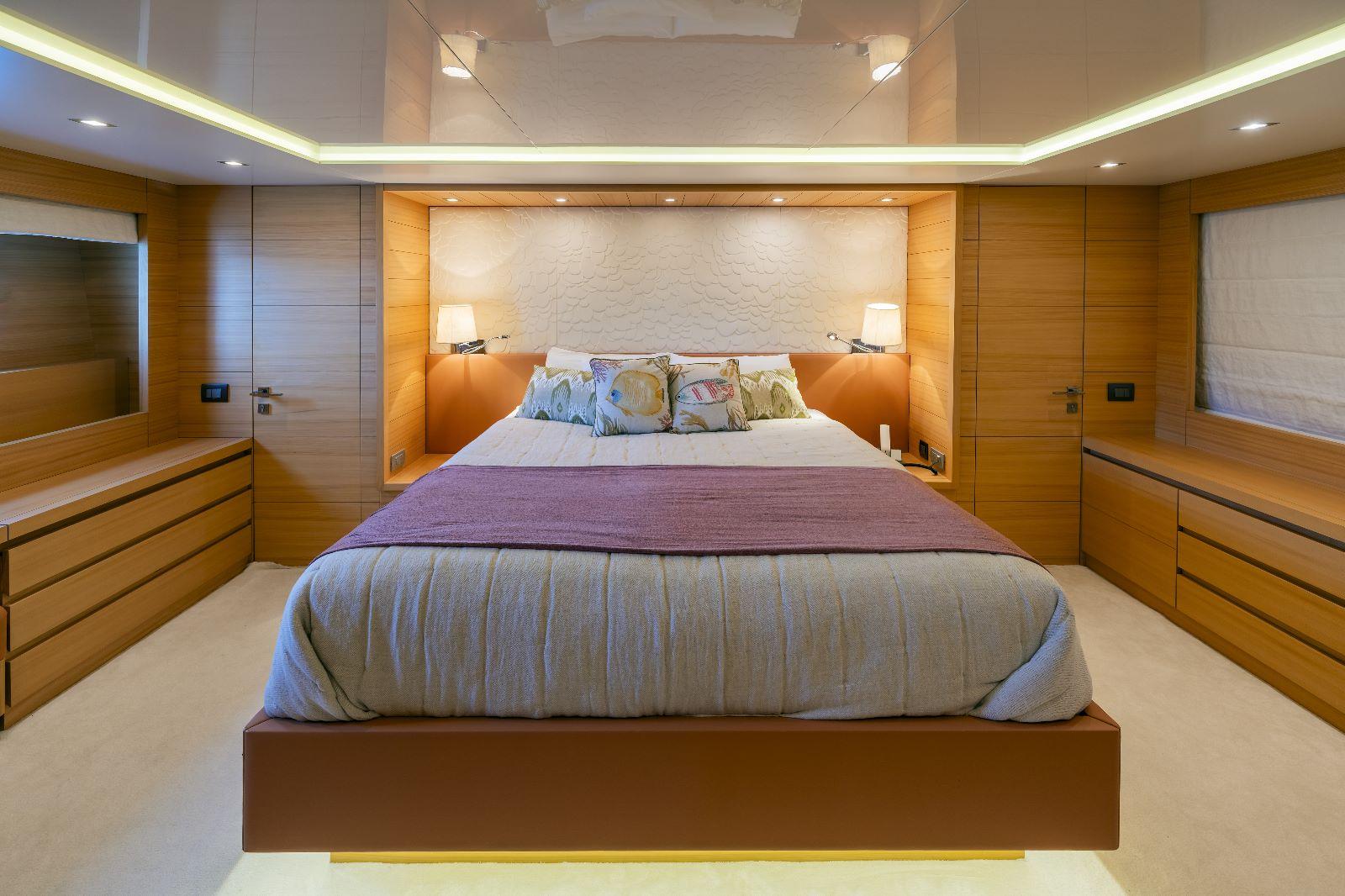 Luxurious bedroom interior on 2011 Maiora 27 yacht, featuring modern design and ambient lighting.